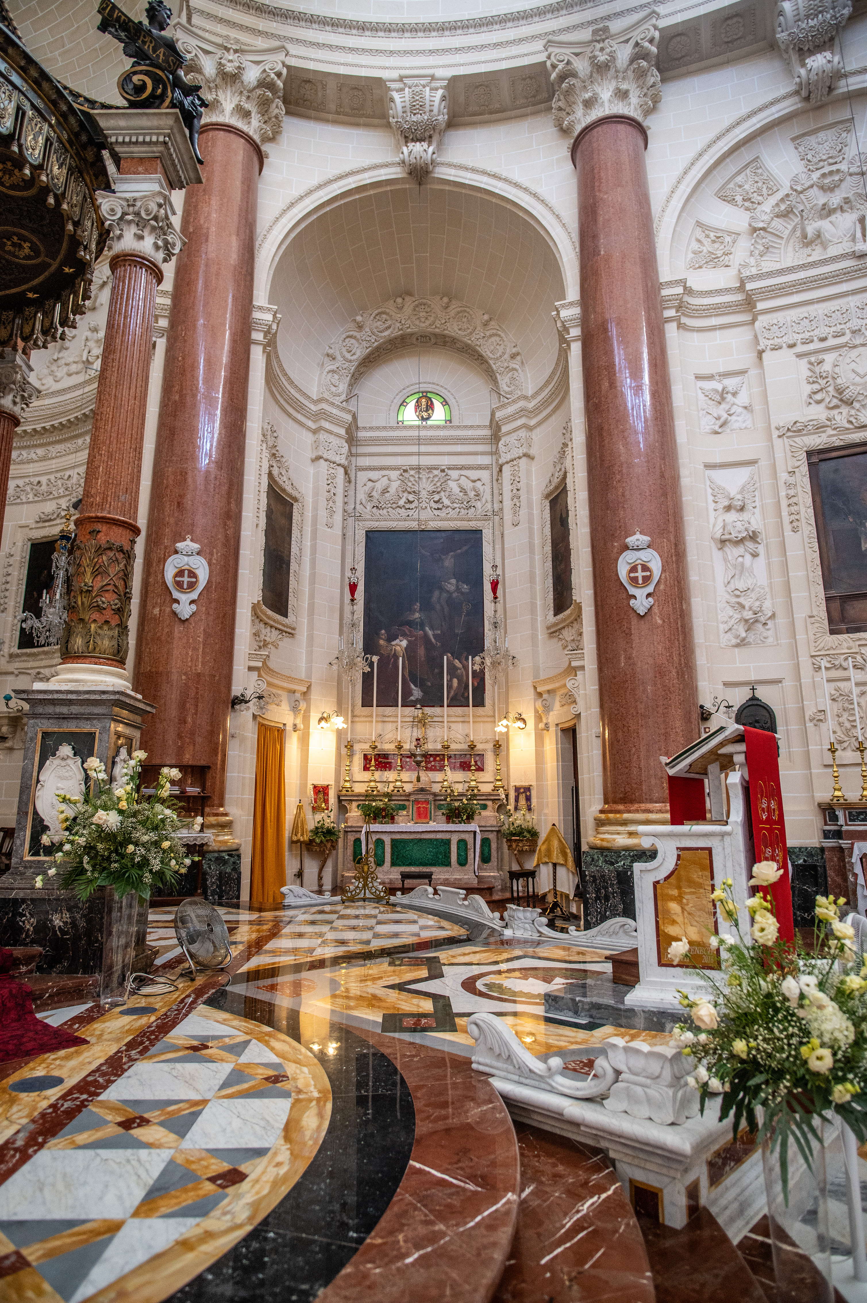 tall, red marble columns with intricate white capitals