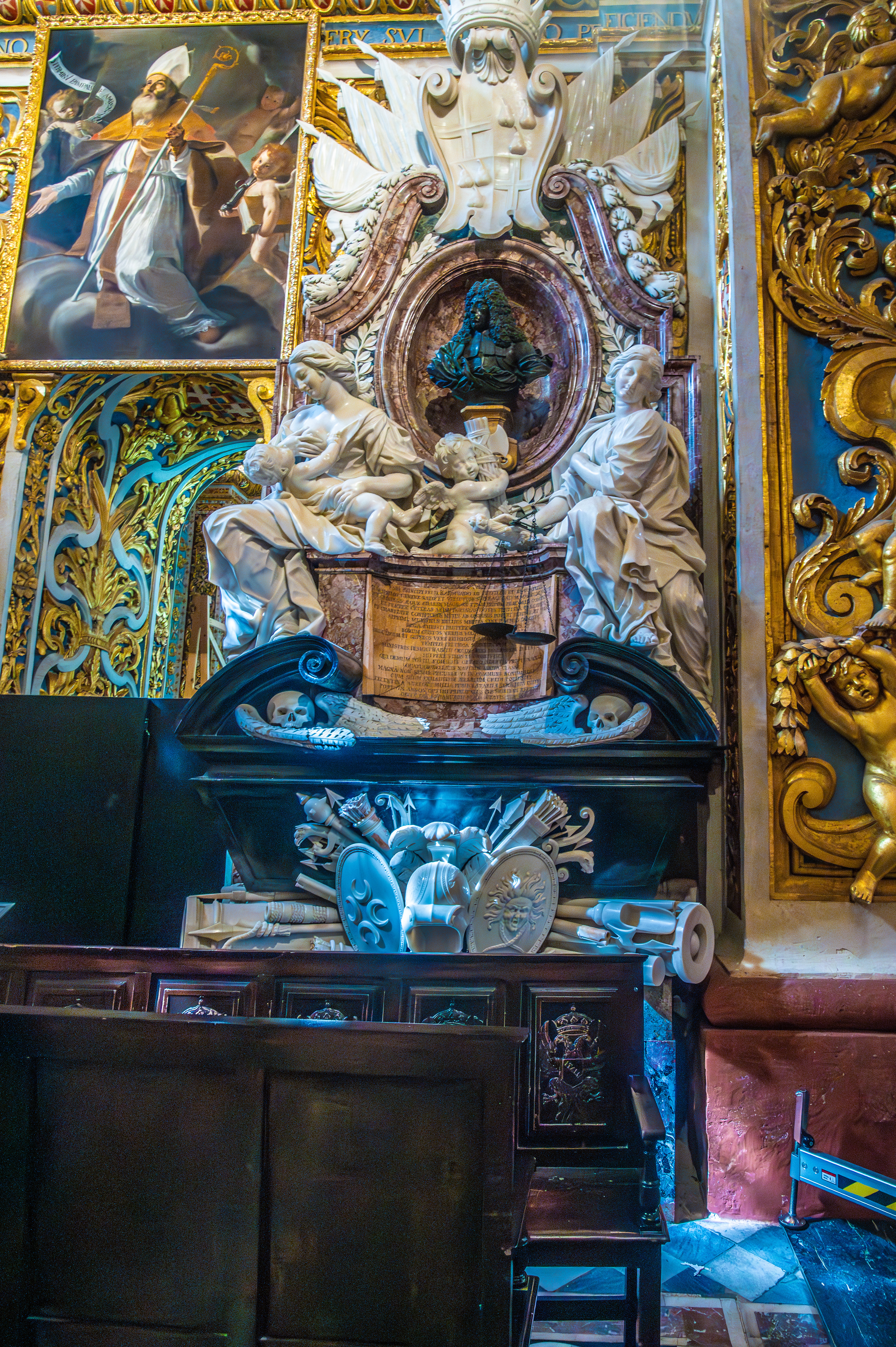 central sculpture of a seated figure with angels