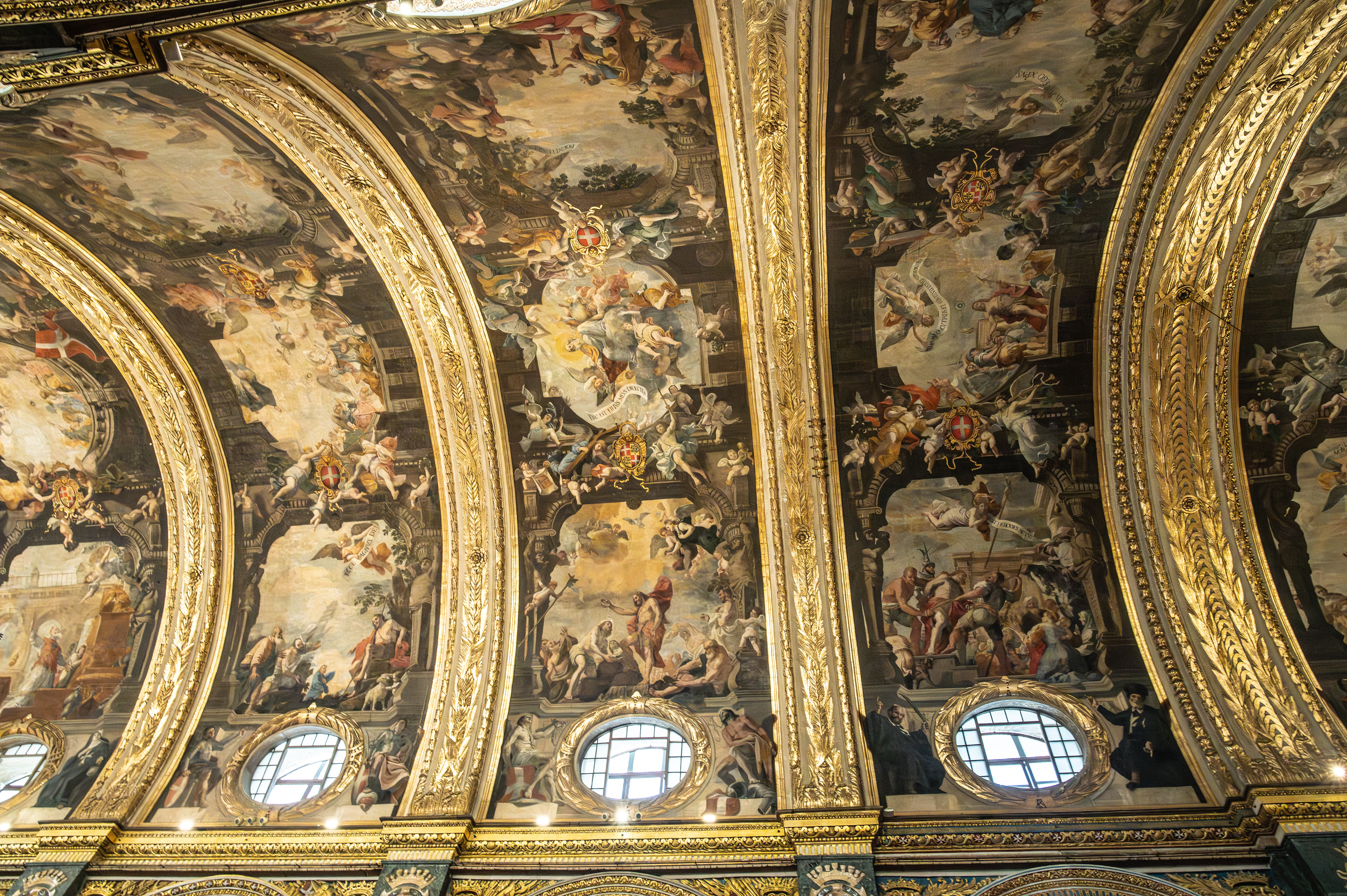 The ceiling is adorned with intricate frescoes and elaborate gold decorations