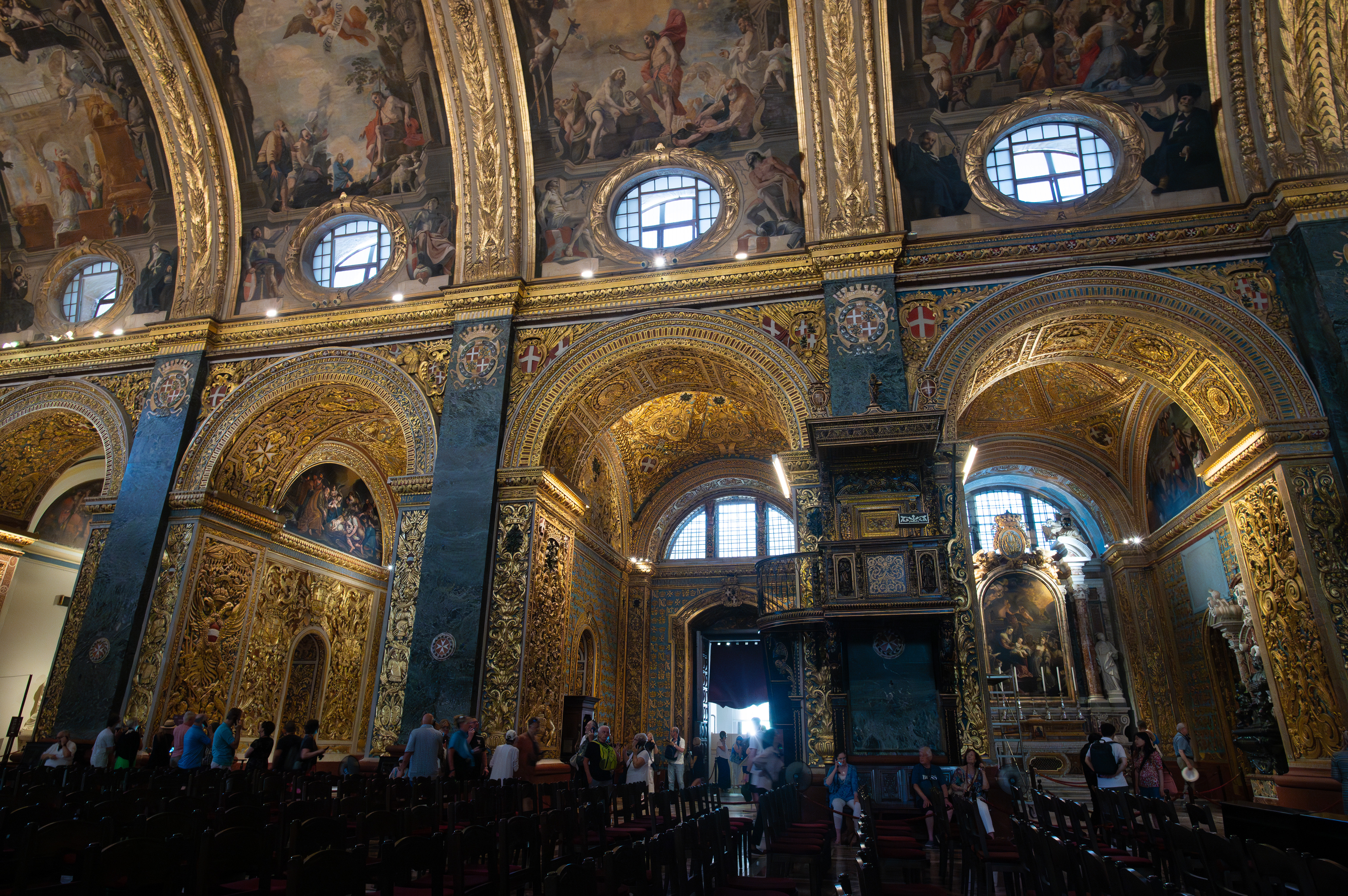 The architecture features intricate gold and blue detailing, with multiple arches and columns