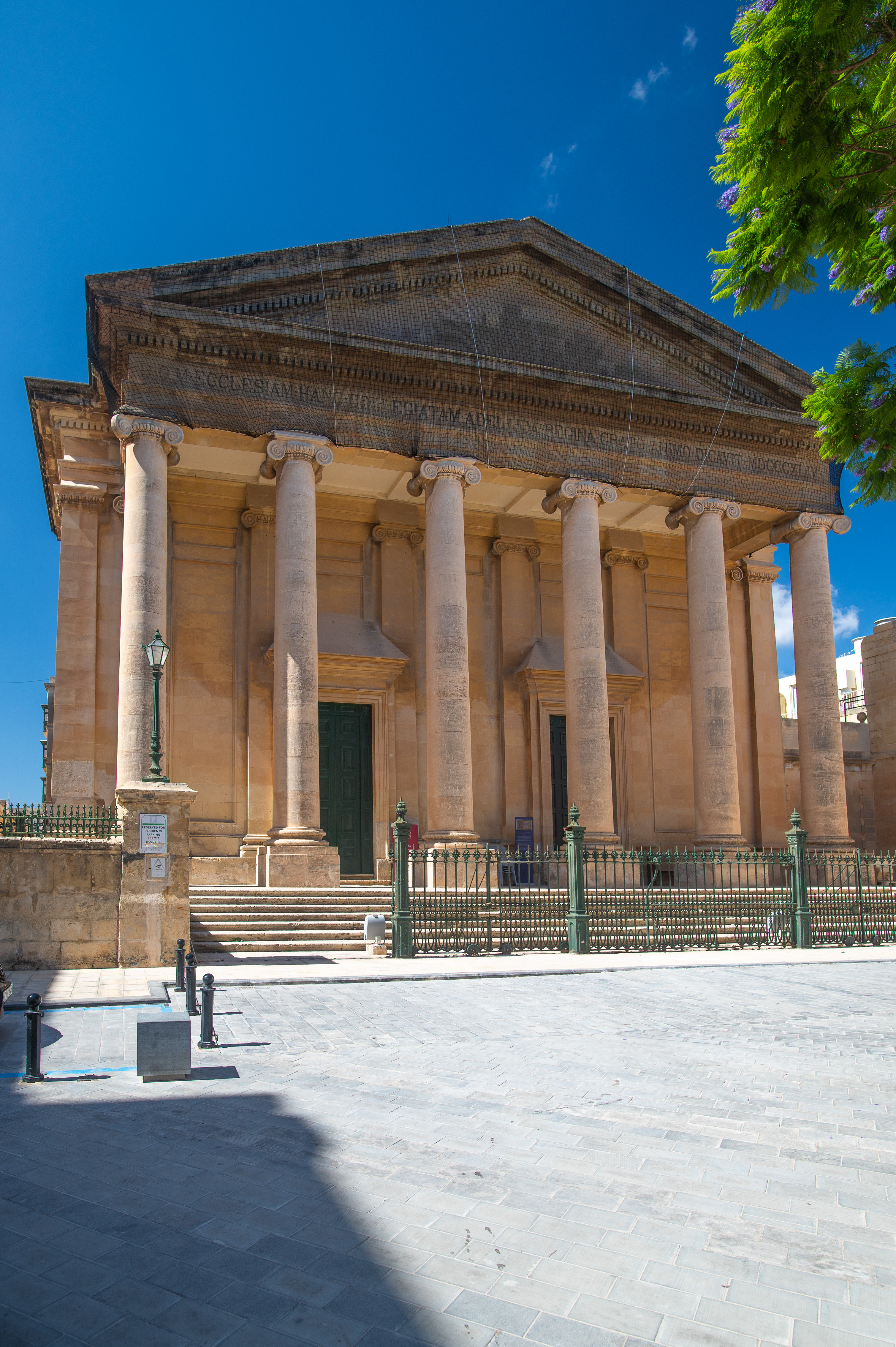 a neoclassical building with a portico supported by six large columns