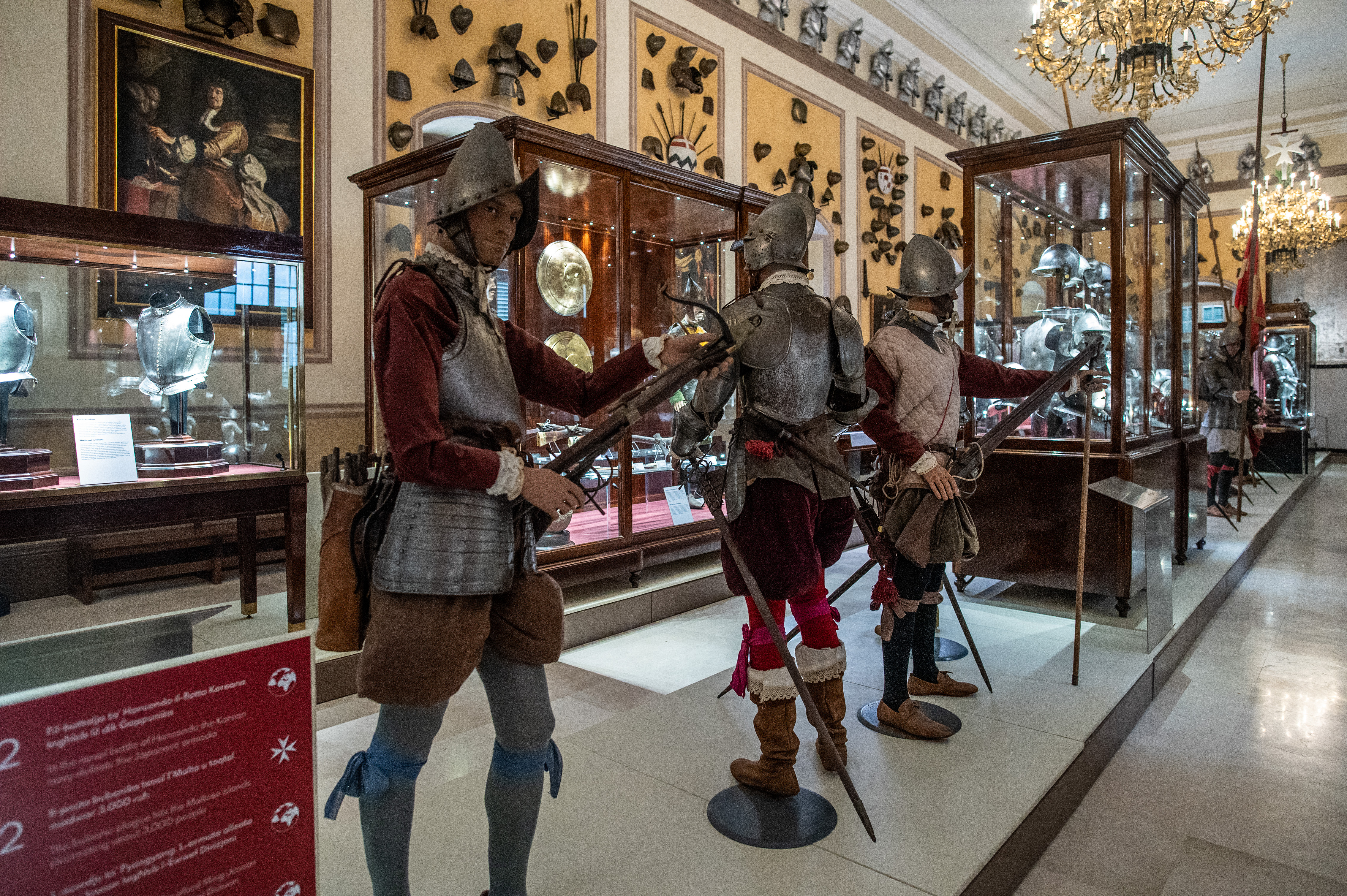 Three mannequins are dressed in period armor