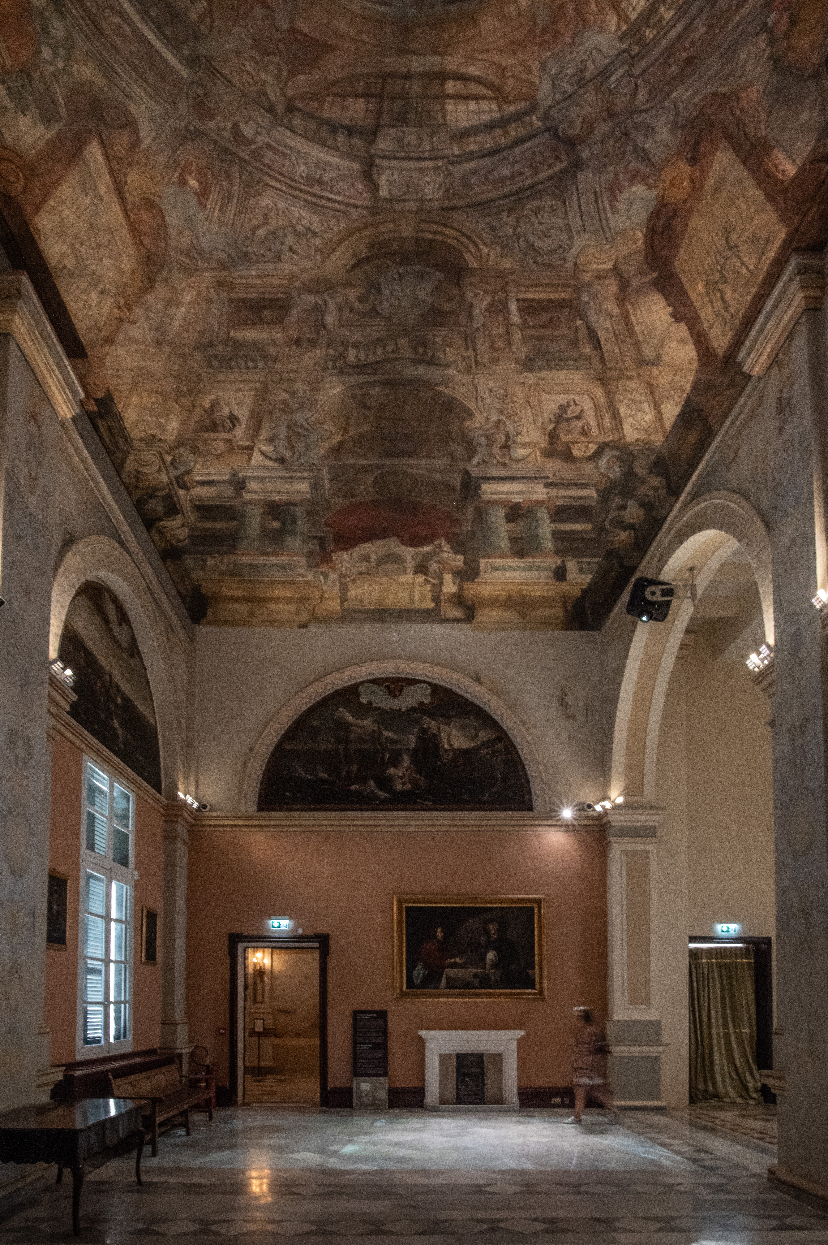 a high ceiling adorned with intricate frescoes