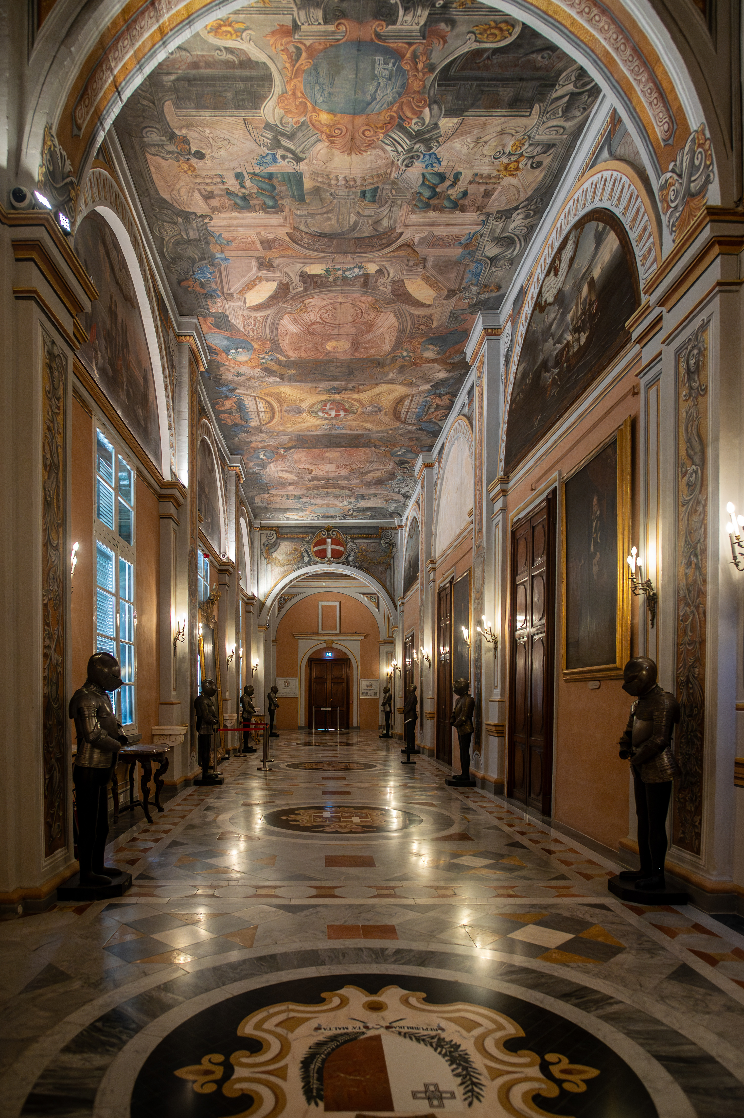 a grand, ornate hallway with a highly decorated ceiling