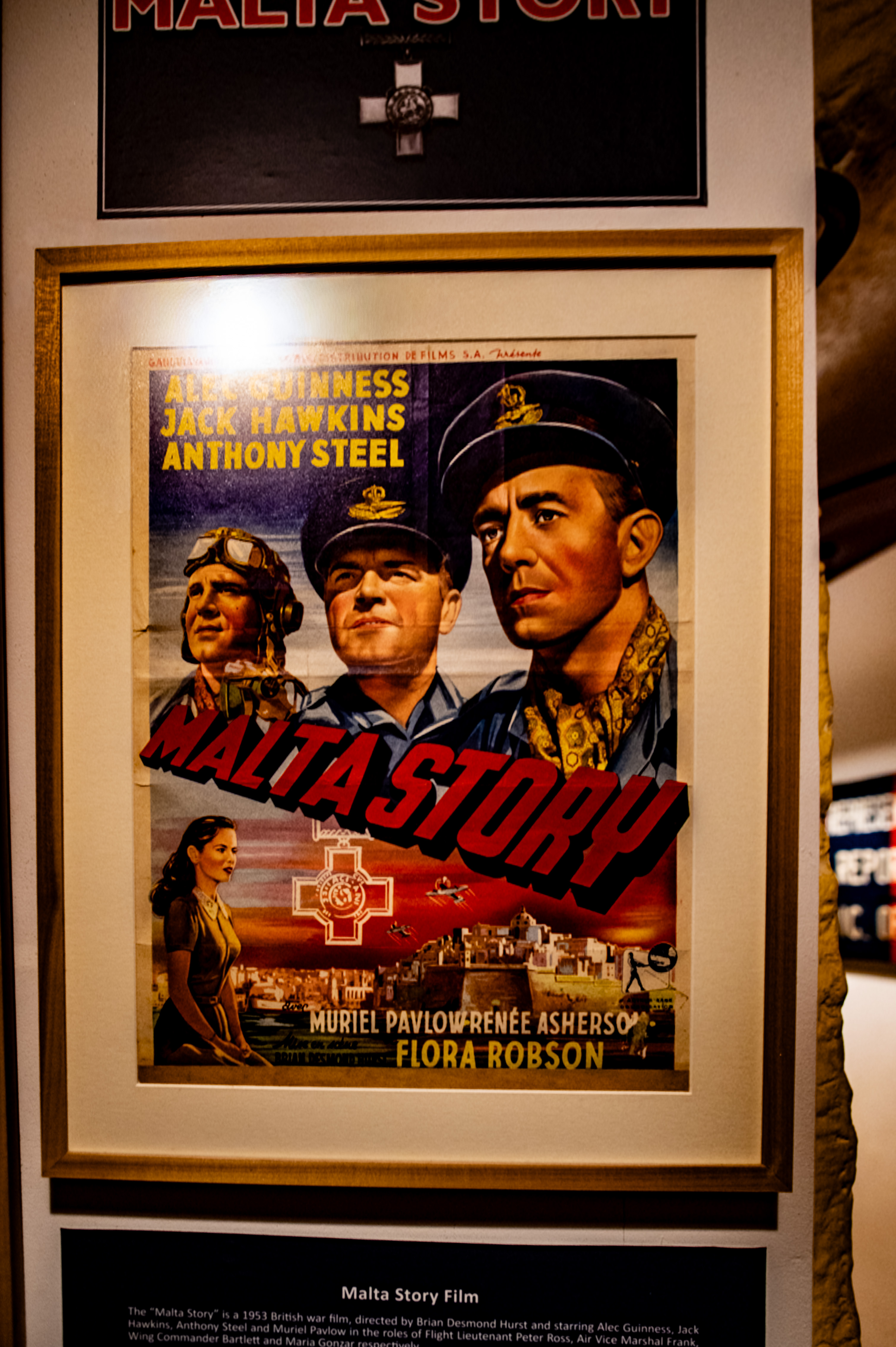 a framed poster for the 1953 British war film 'Malta Story,' 