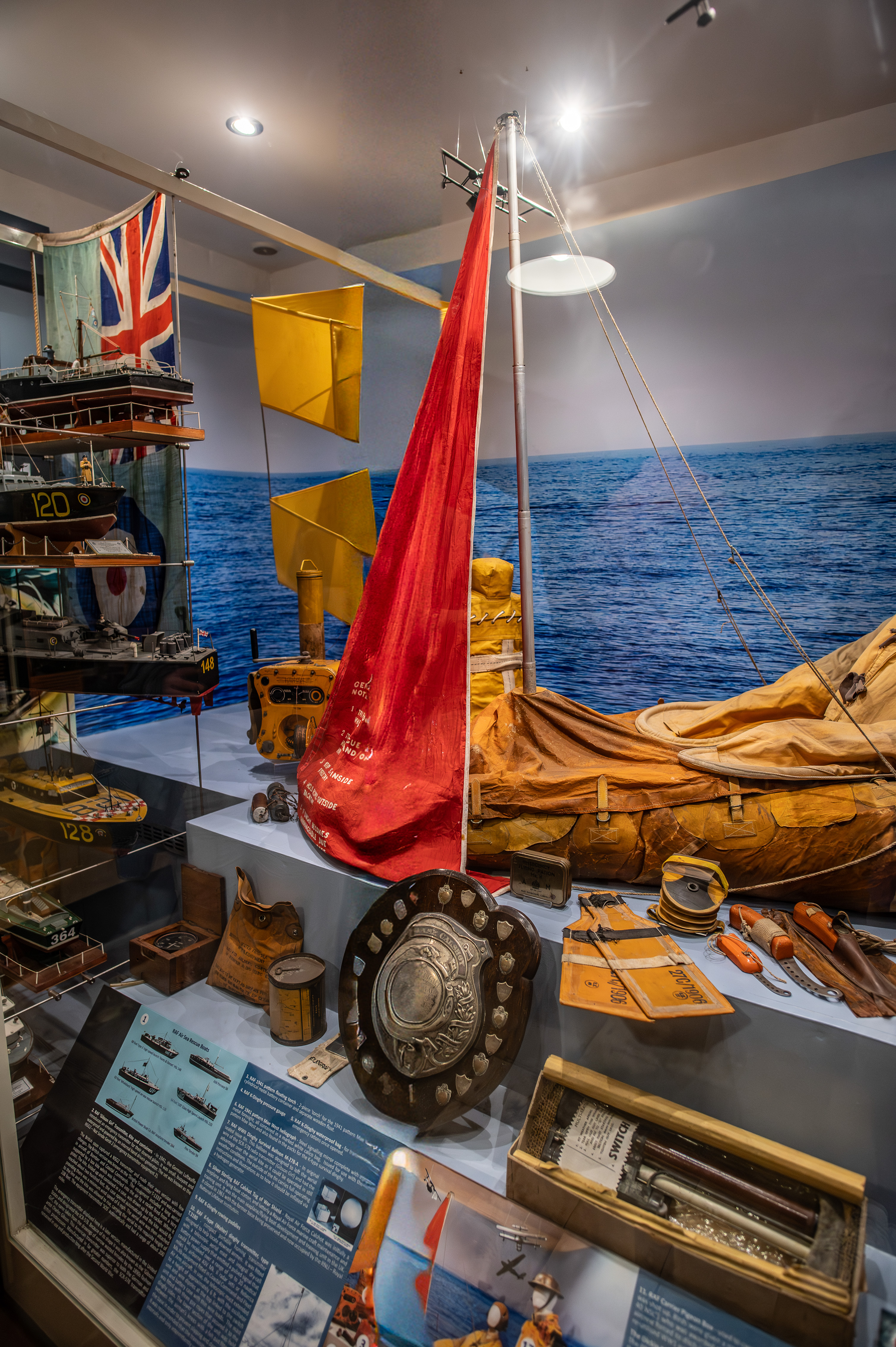 various nautical artifacts such as a ship's wheel, navigational tools, and a red flag