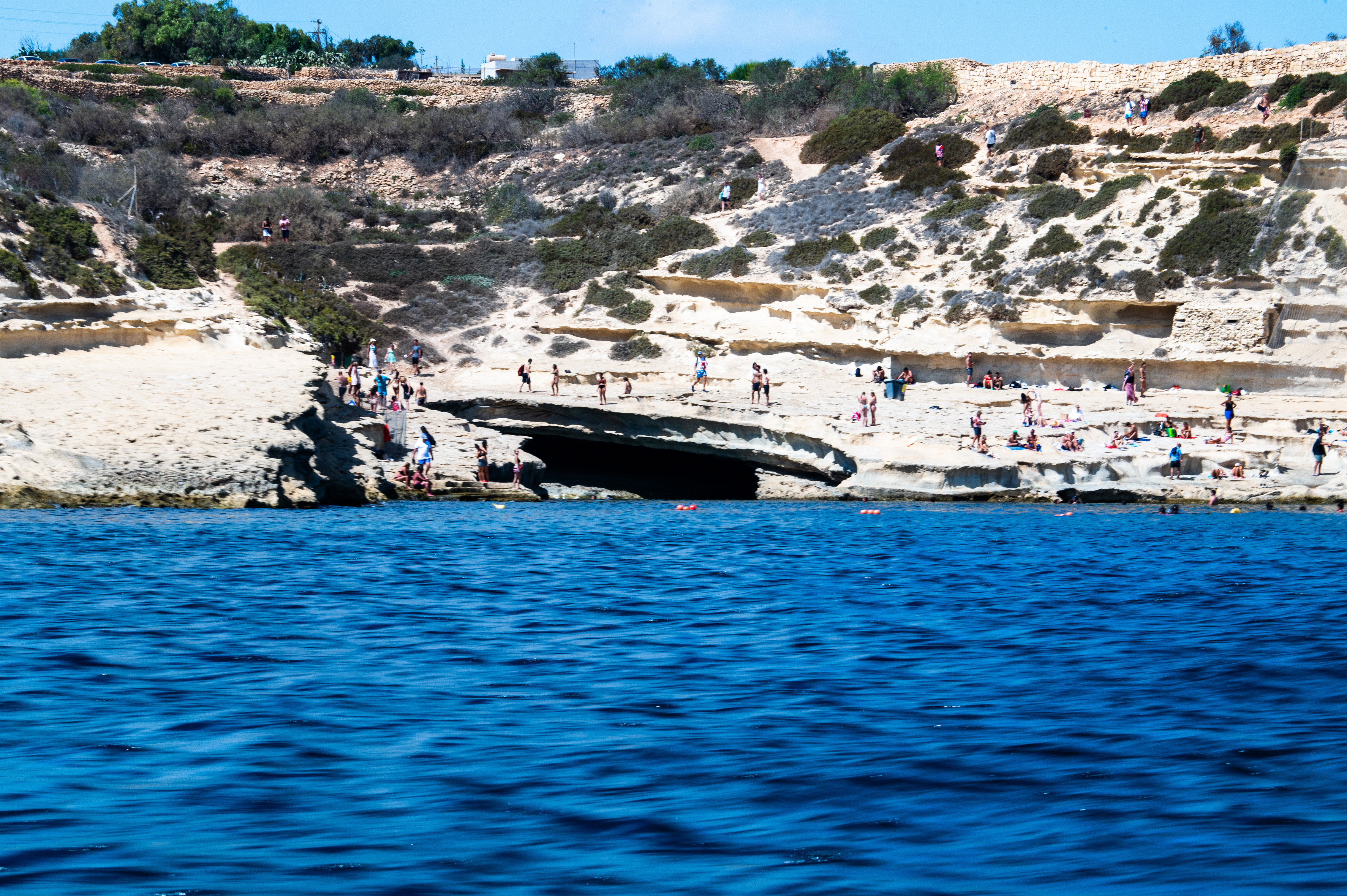 People are seen sunbathing