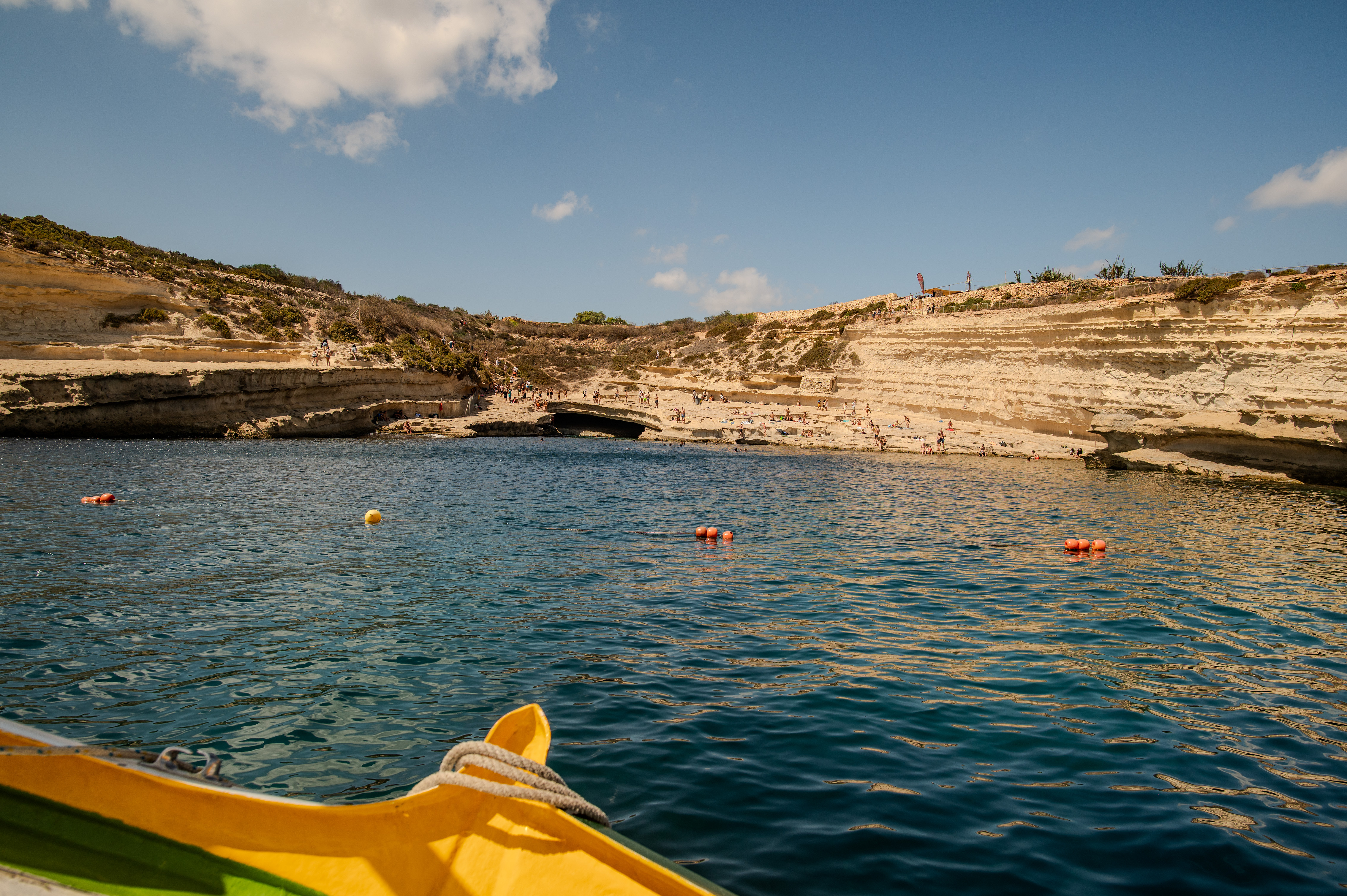 People are seen swimming, sunbathing