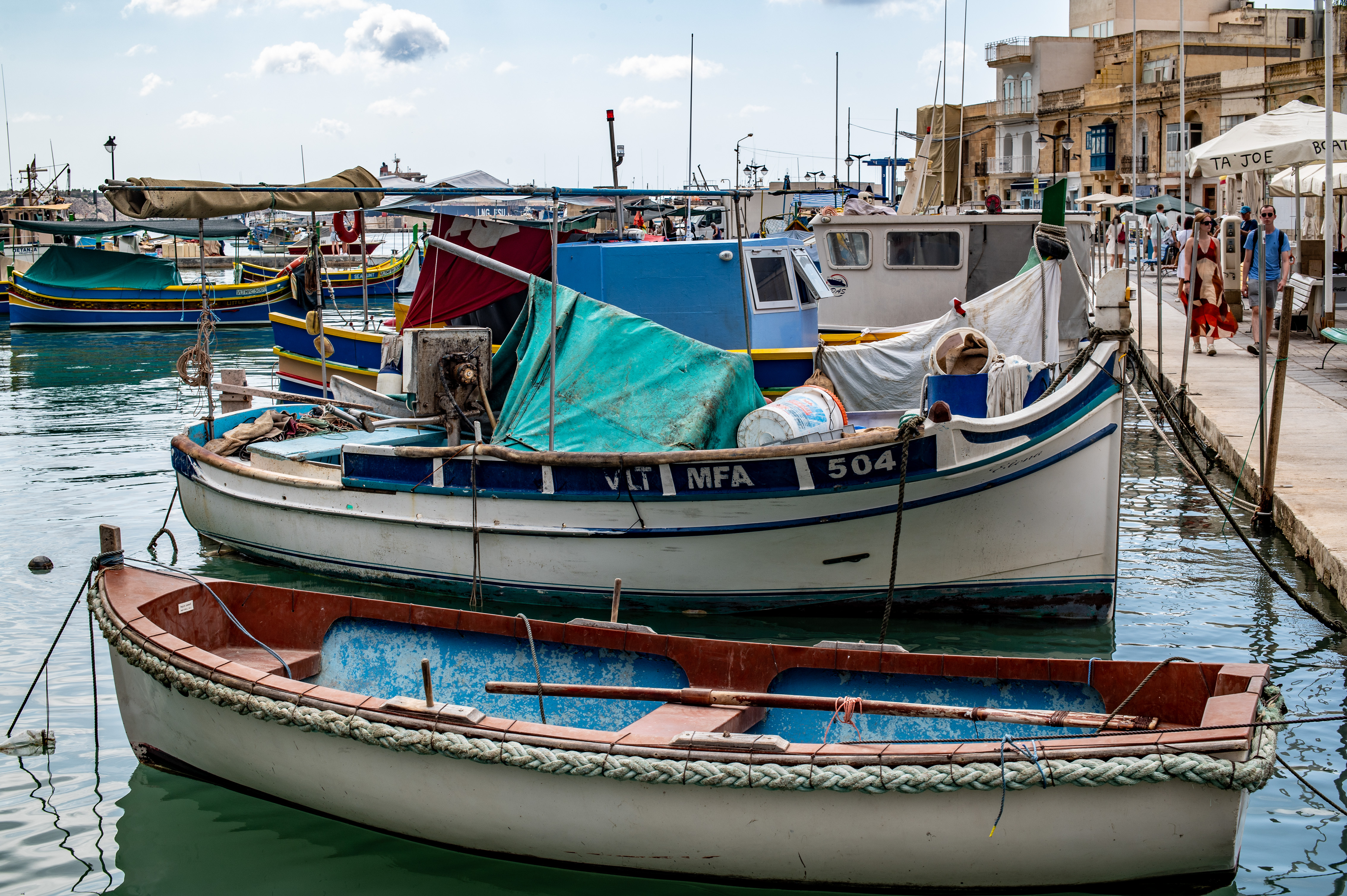several small boats docked at a pier