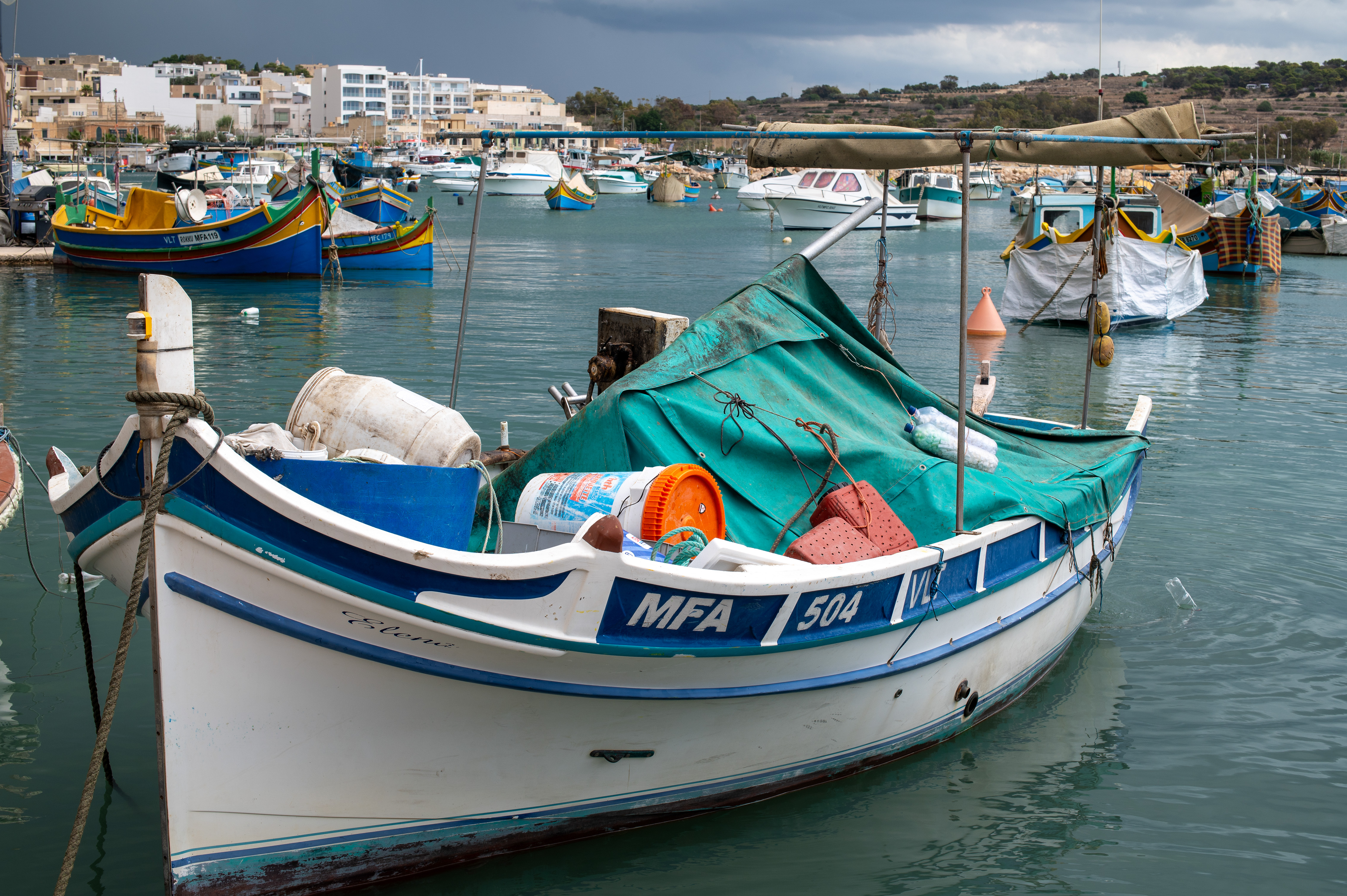 The foreground features a small fishing boat