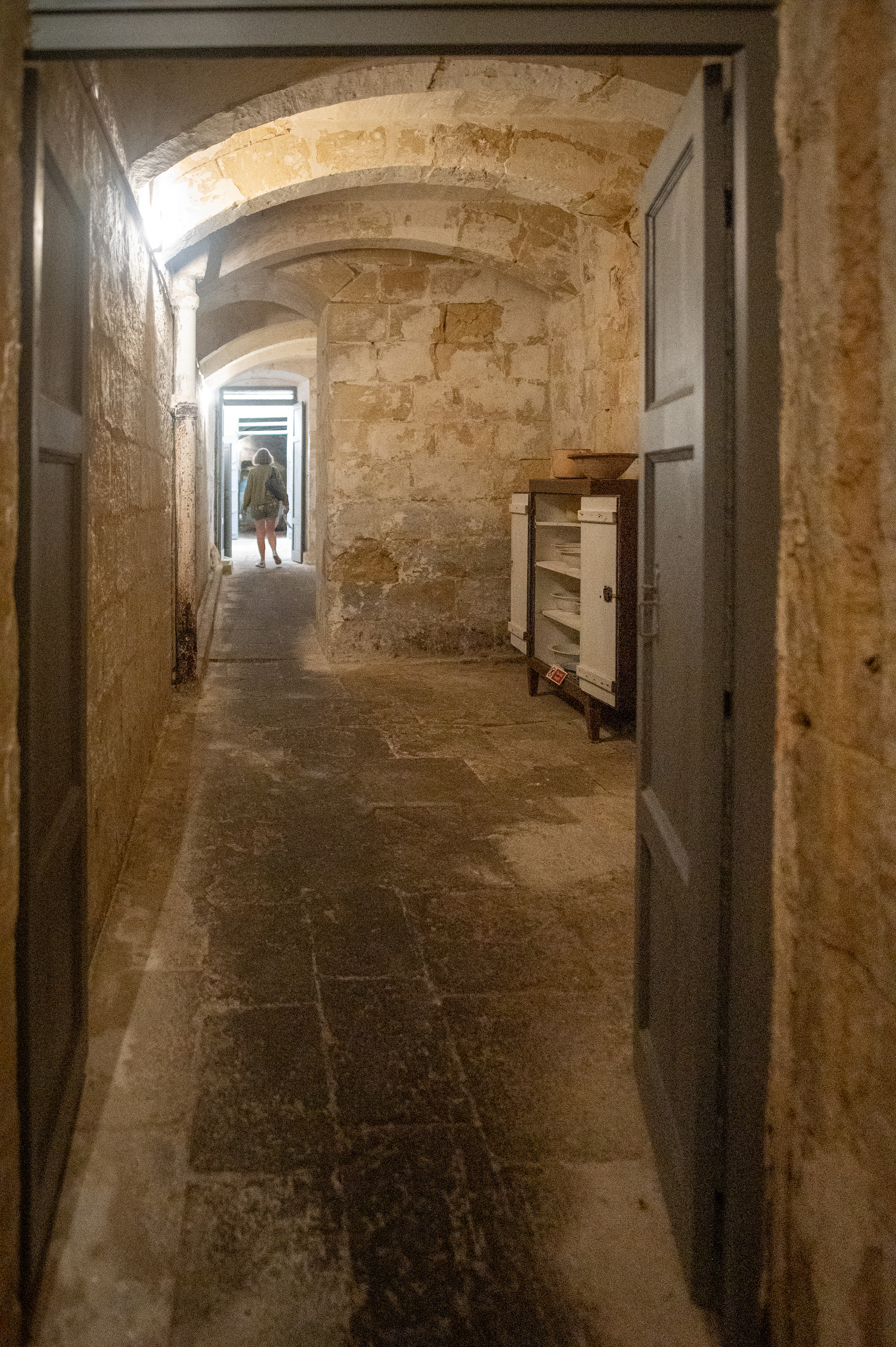 a narrow, arched stone corridor