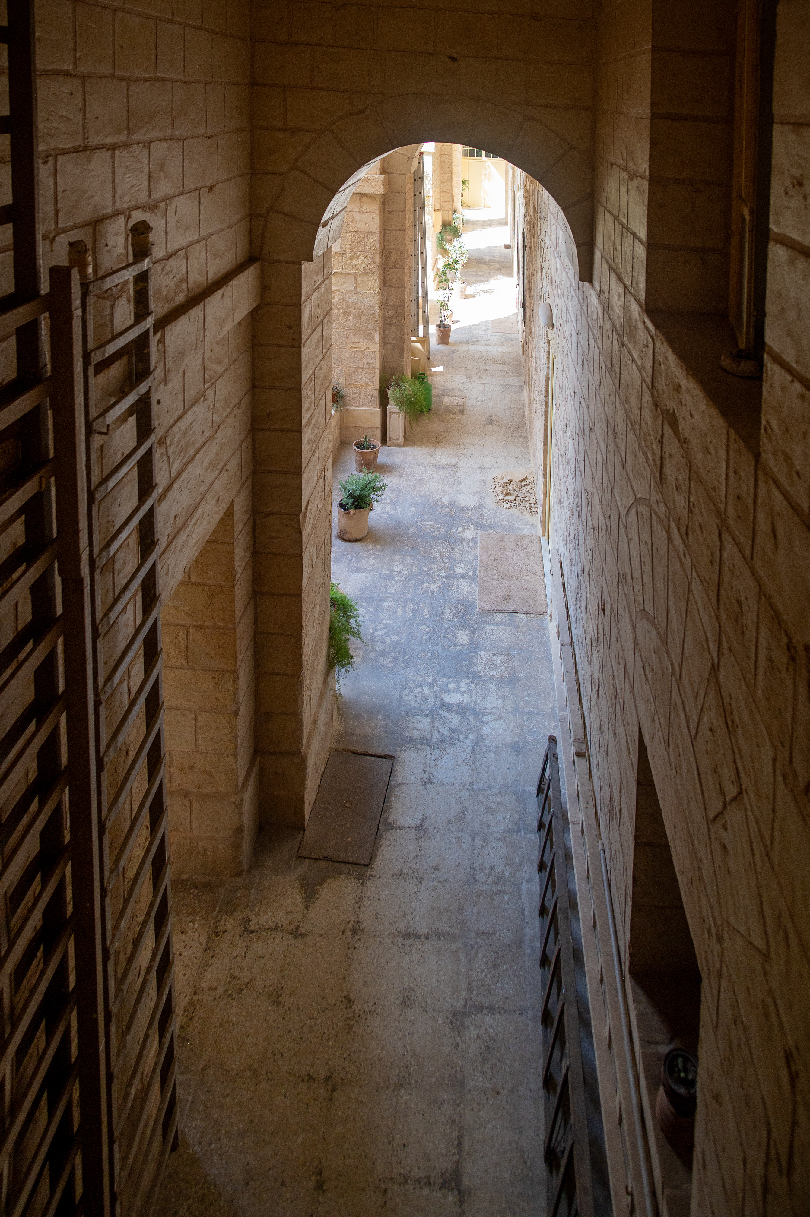 a narrow, arched stone passageway with a slight incline