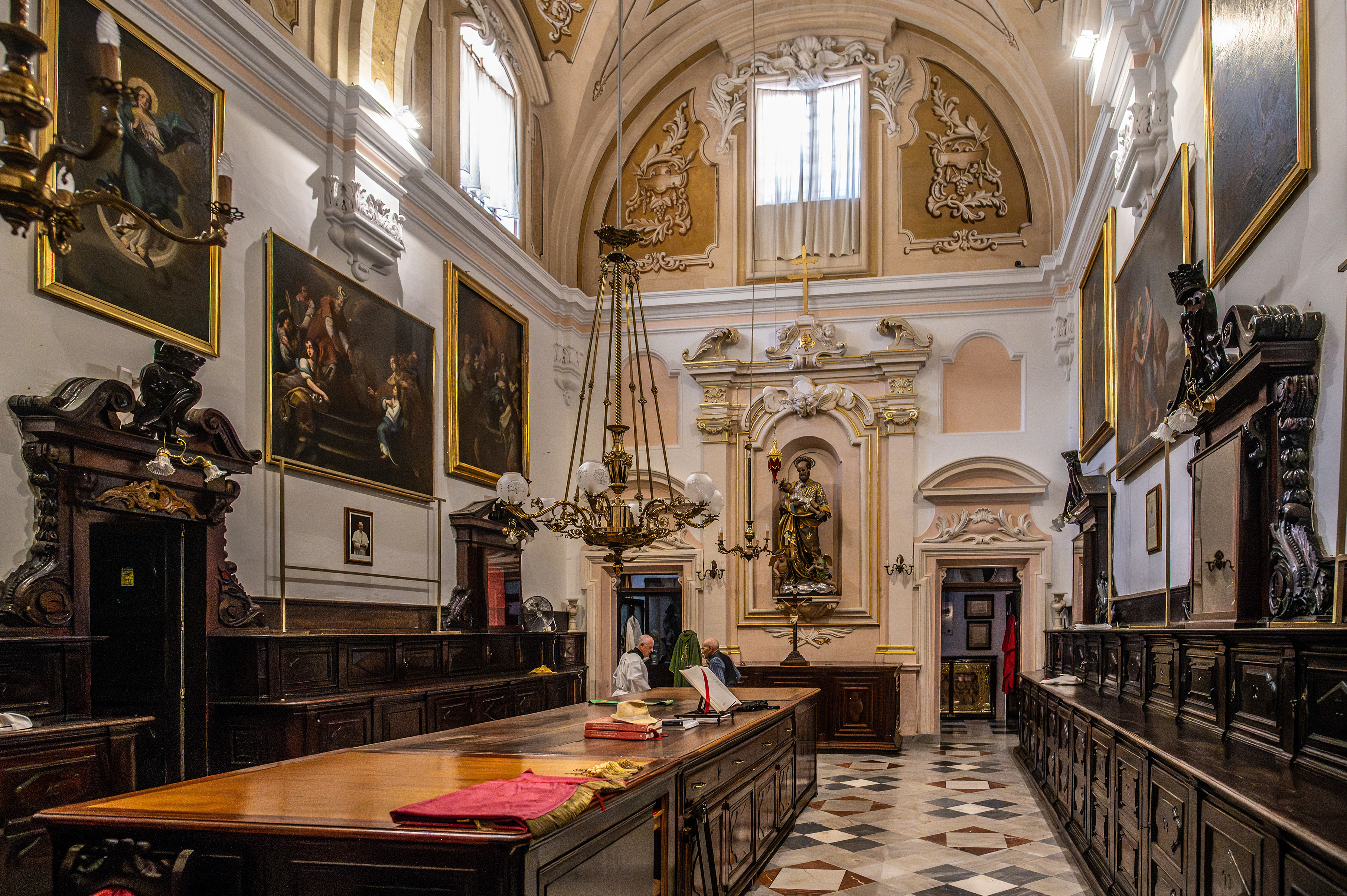 A central altar with a statue of a saint is prominently displayed