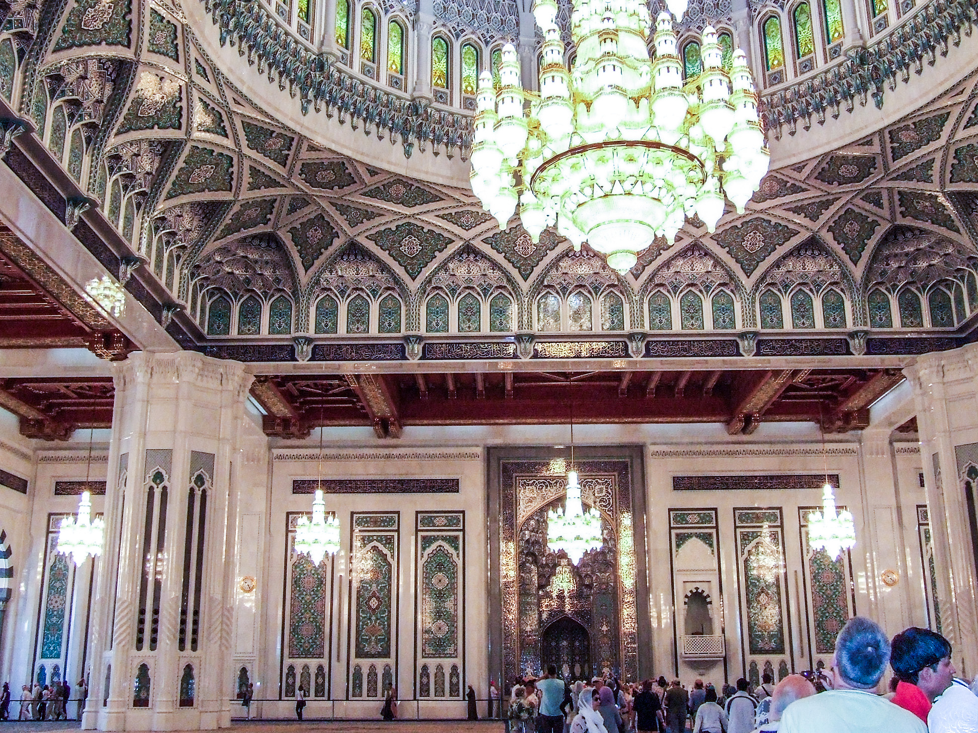 The ceiling is adorned with detailed patterns and stained glass windows