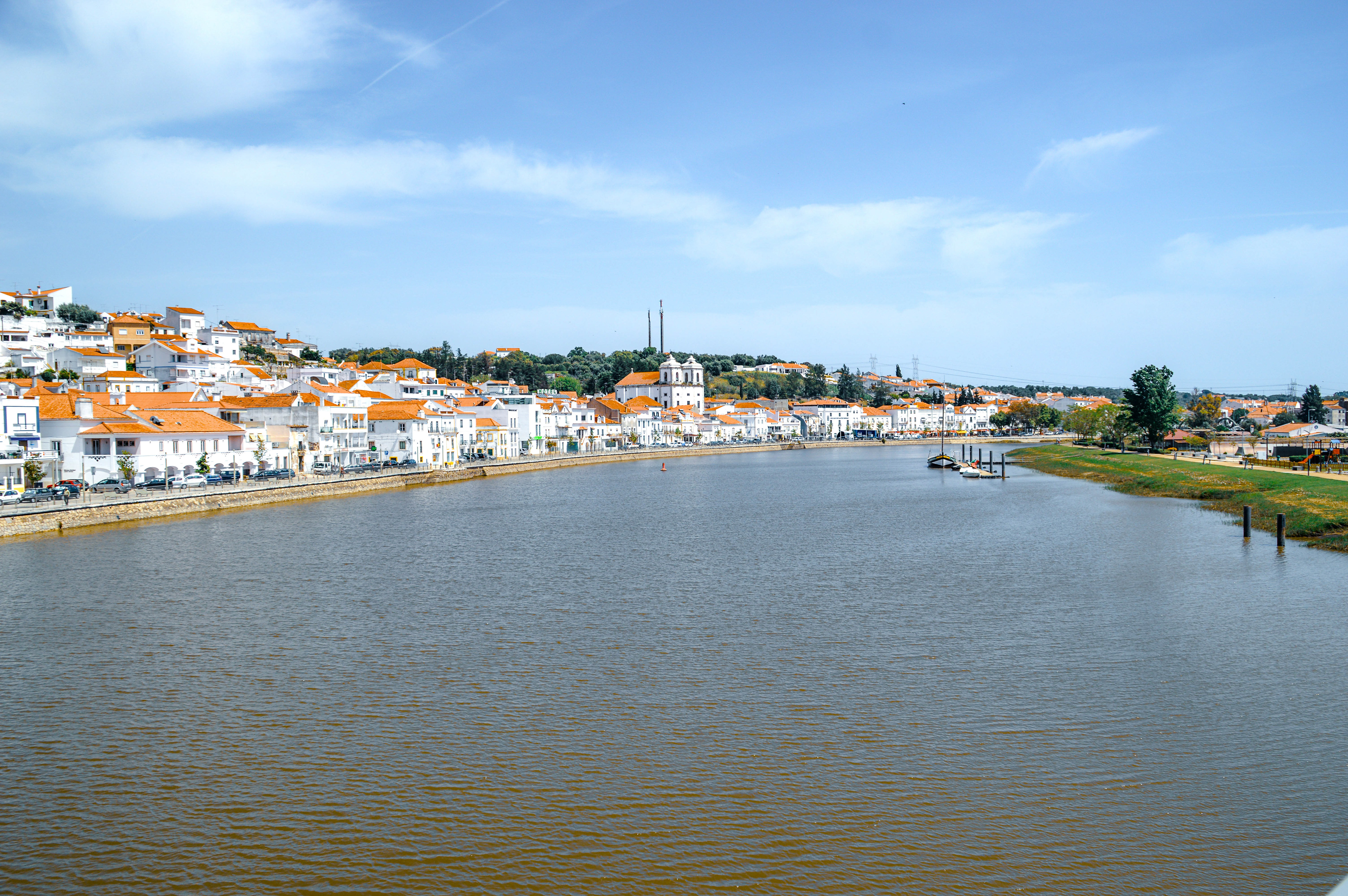 white buildings and orange roofs along a river