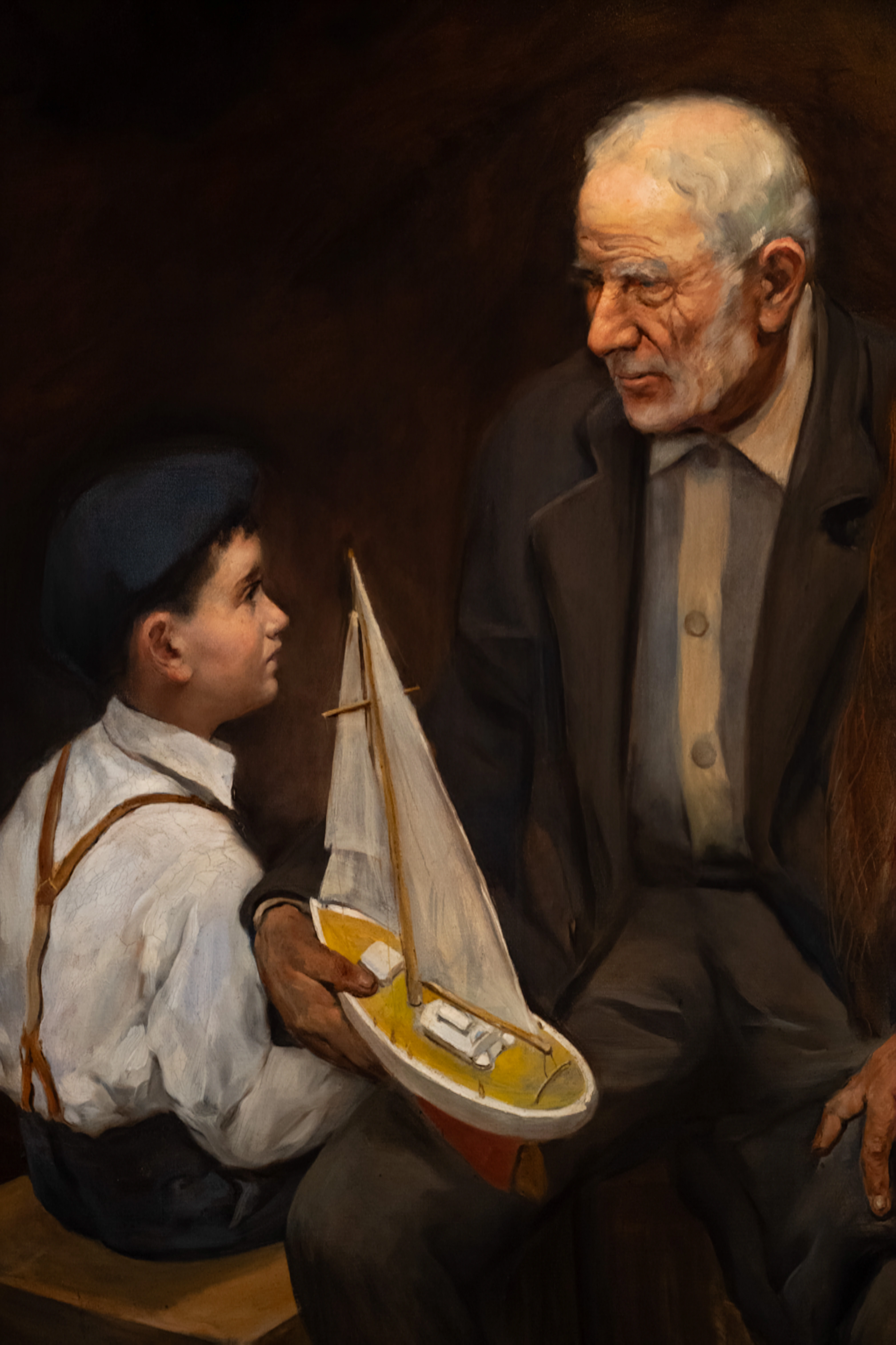 A painting of two figures: an older man with white hair and a younger man in a white shirt and suspenders. The younger man holds a wooden model of a ship, gazing downward, while the older man rests or sleeps
