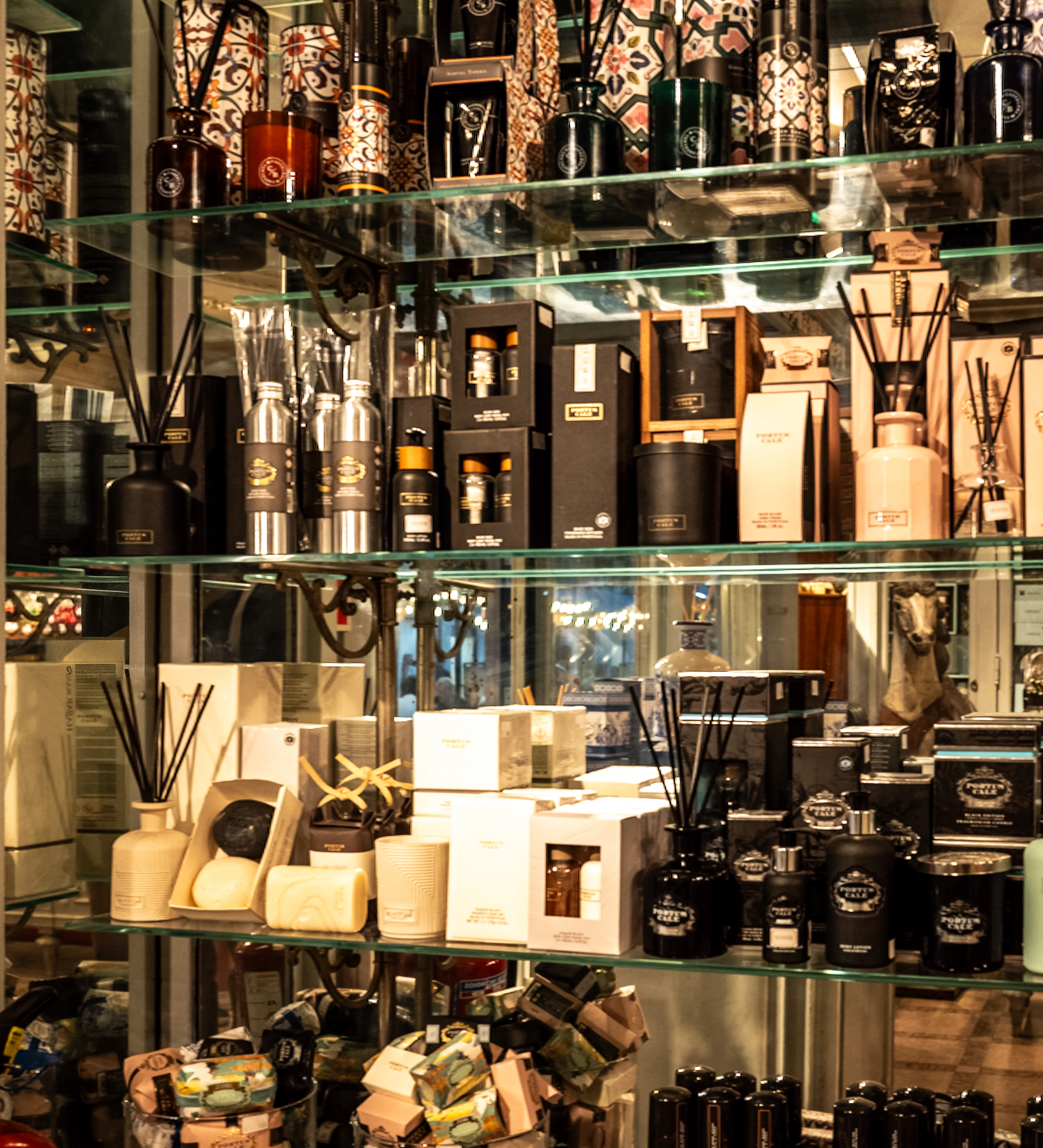 Shelves filled with numerous beautifully packaged biscuits and chocolates in a confectionery shop.