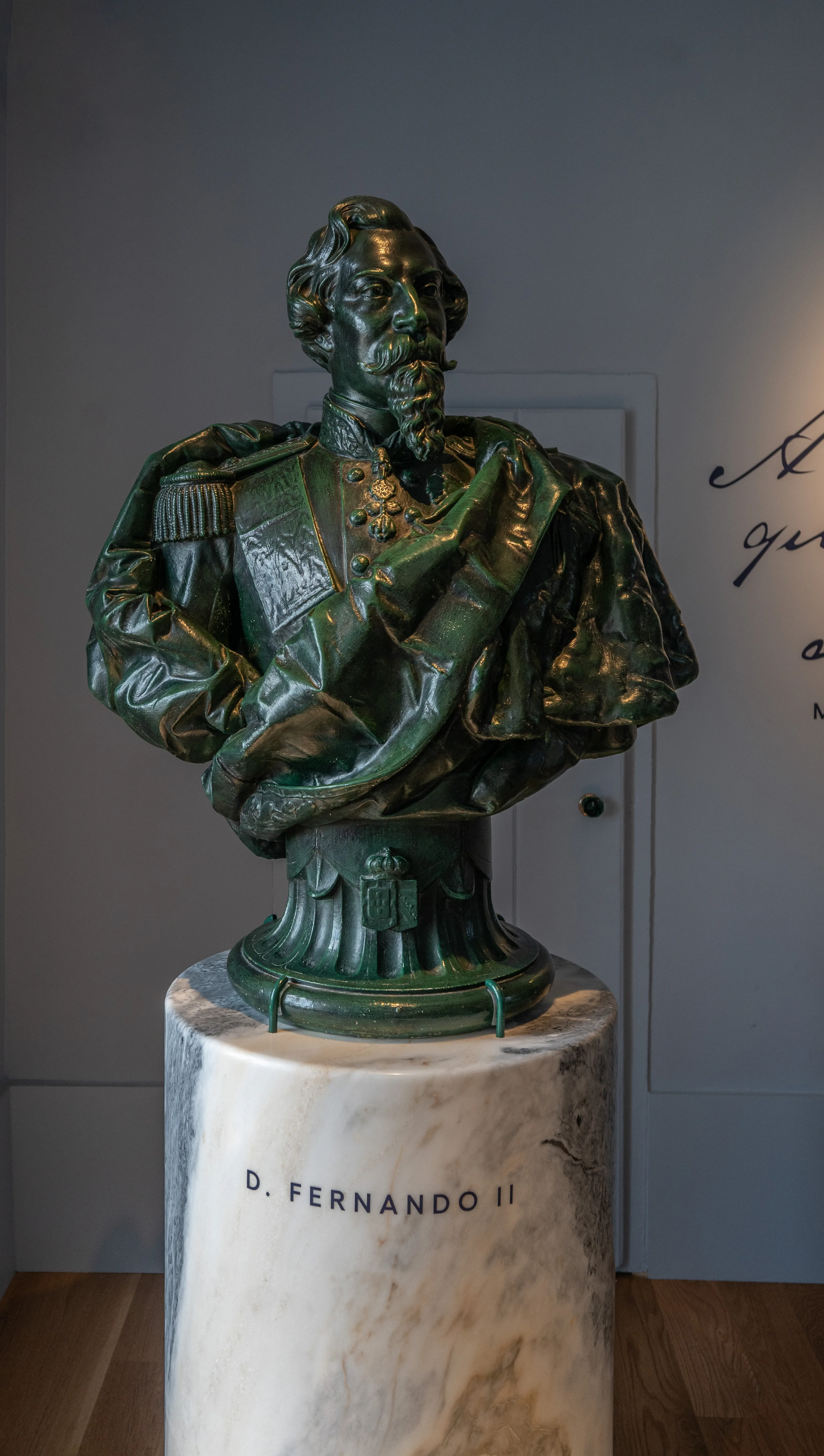 Bronze bust of a man with a beard and medals, dressed in military uniform, displayed on a marble pedestal labelled 