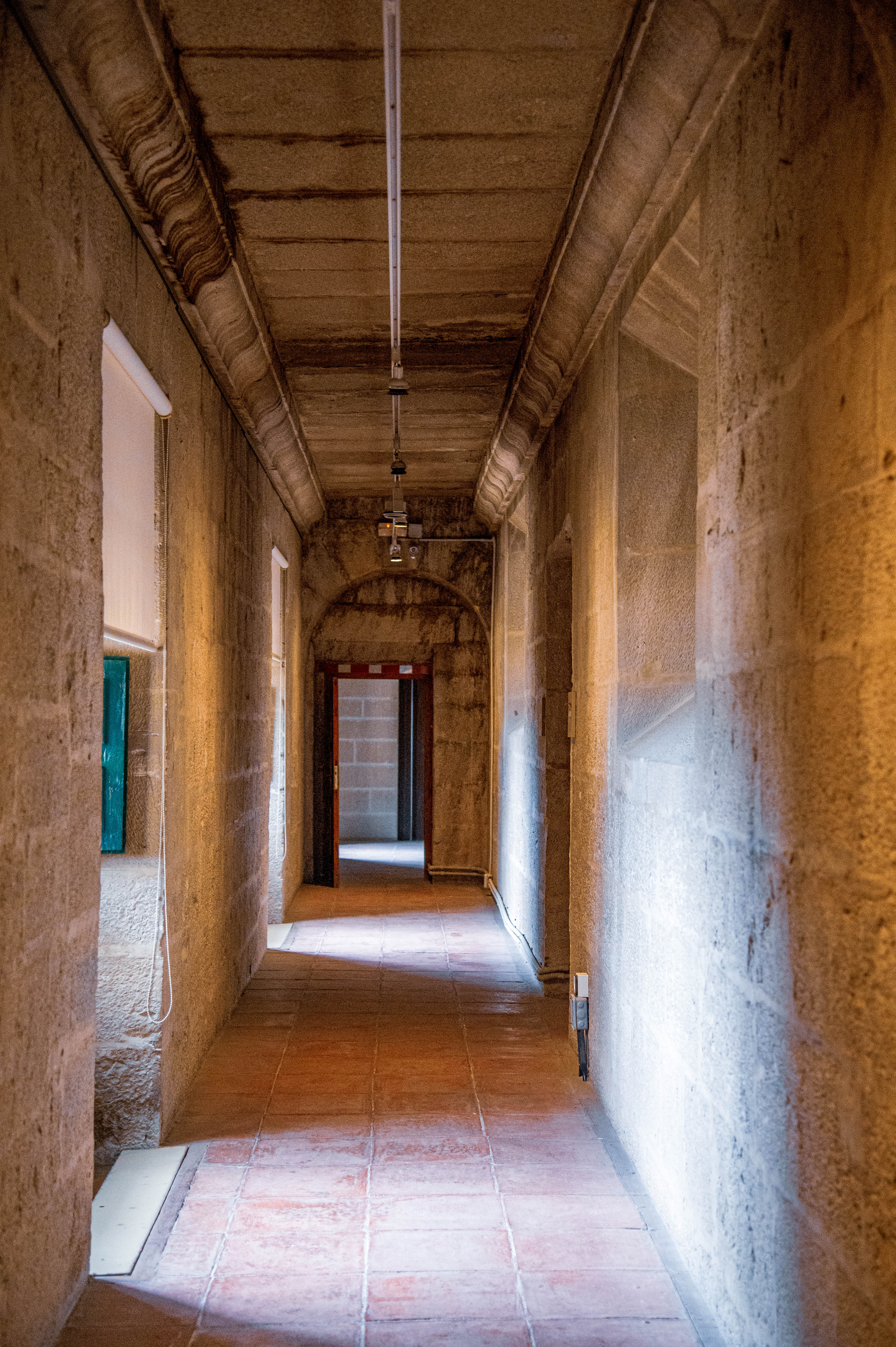 a long, narrow corridor with stone walls