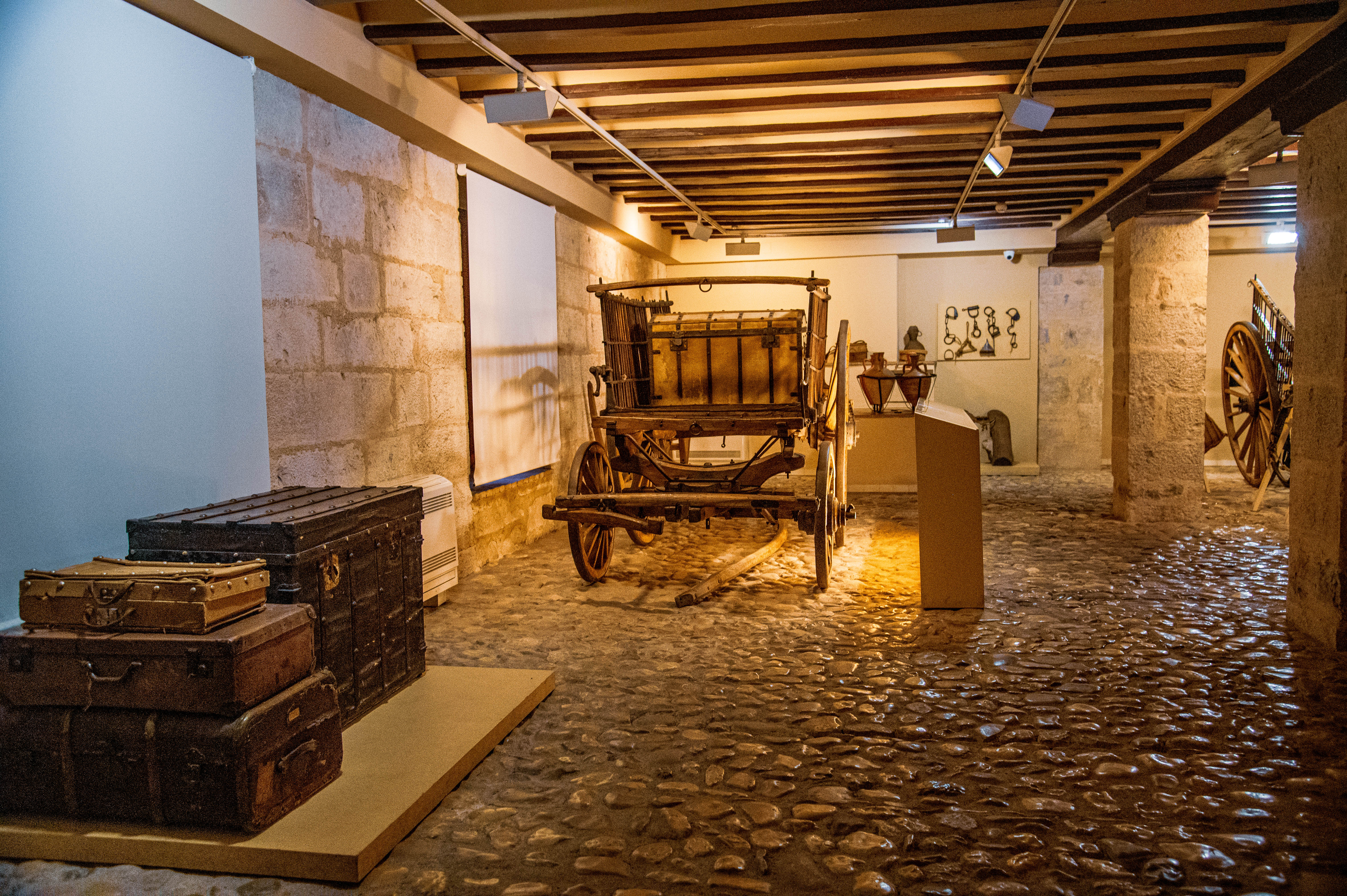 wooden cart and various vintage suitcases