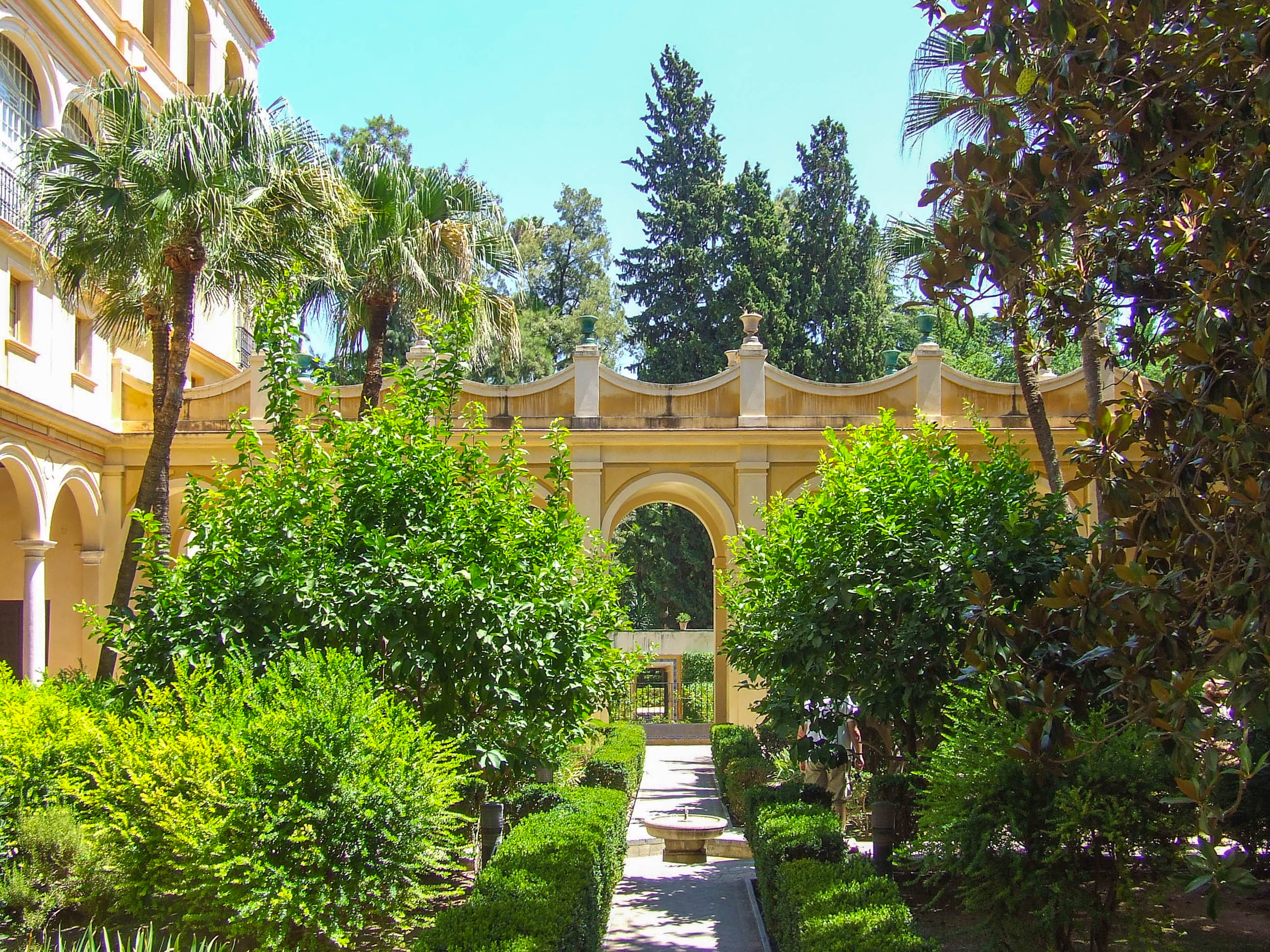 garden with a central pathway leading to a large archway
