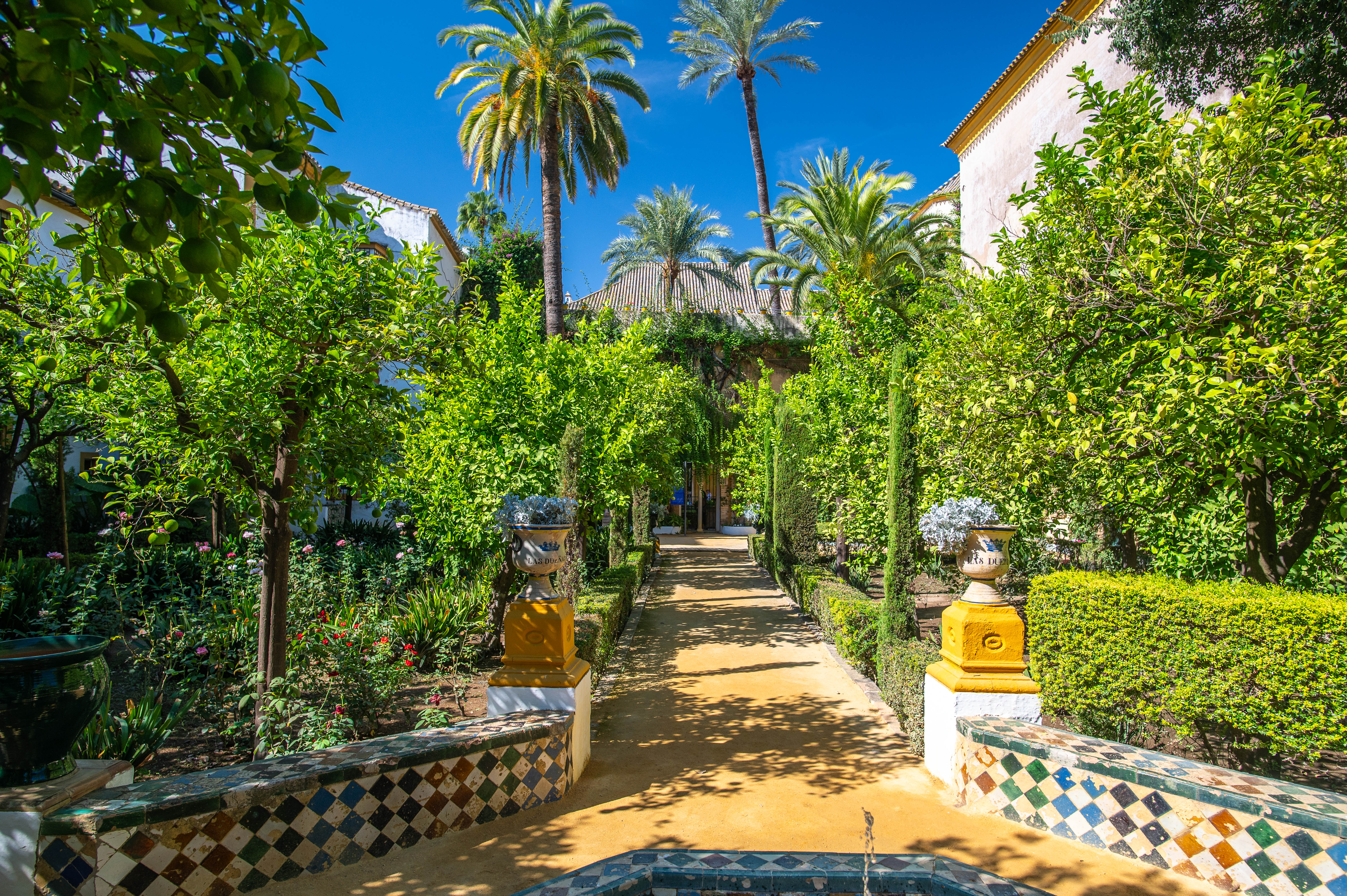 pathway is bordered by colorful, patterned tiles