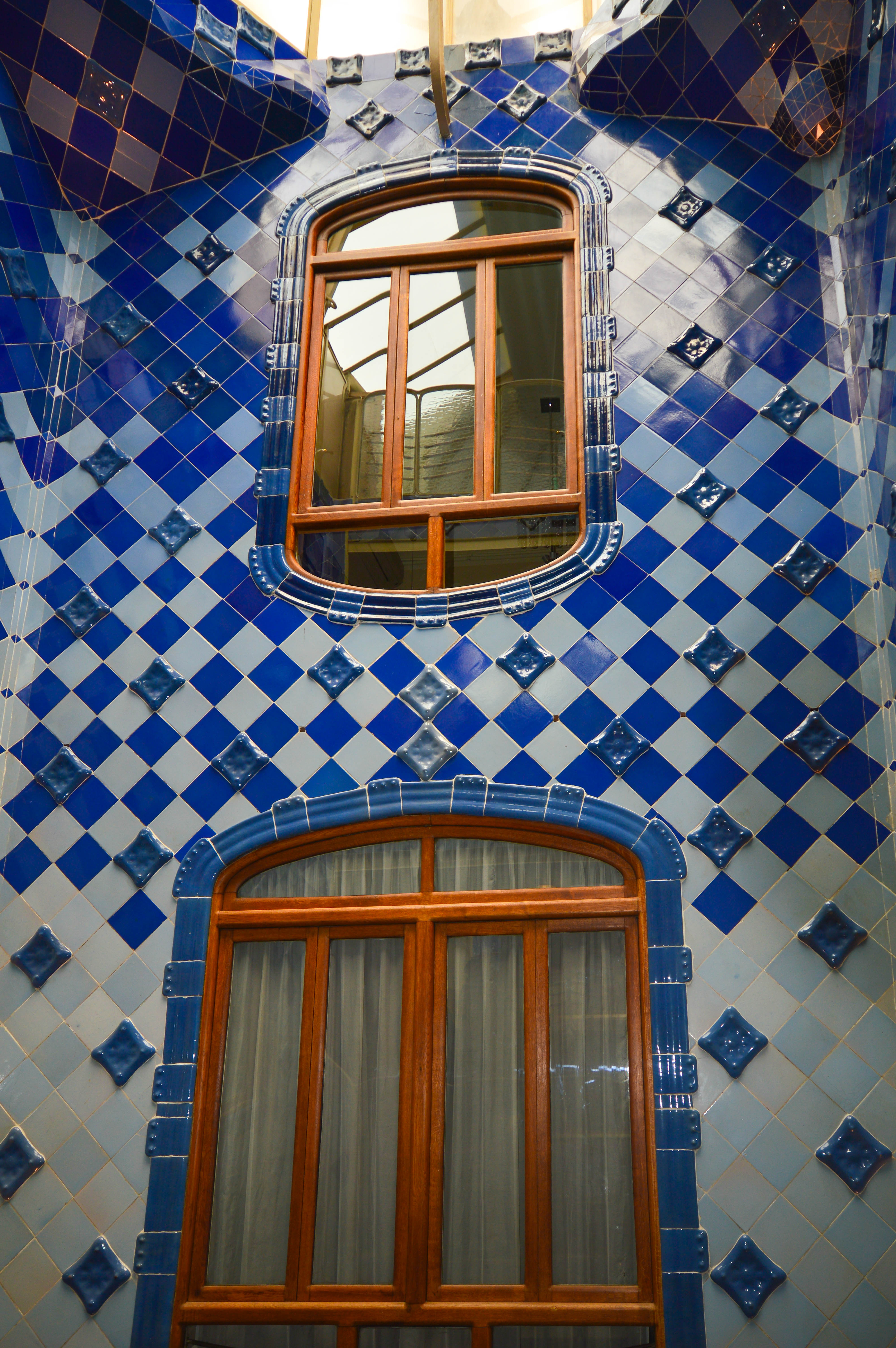 a section of a building adorned with blue and white tiles