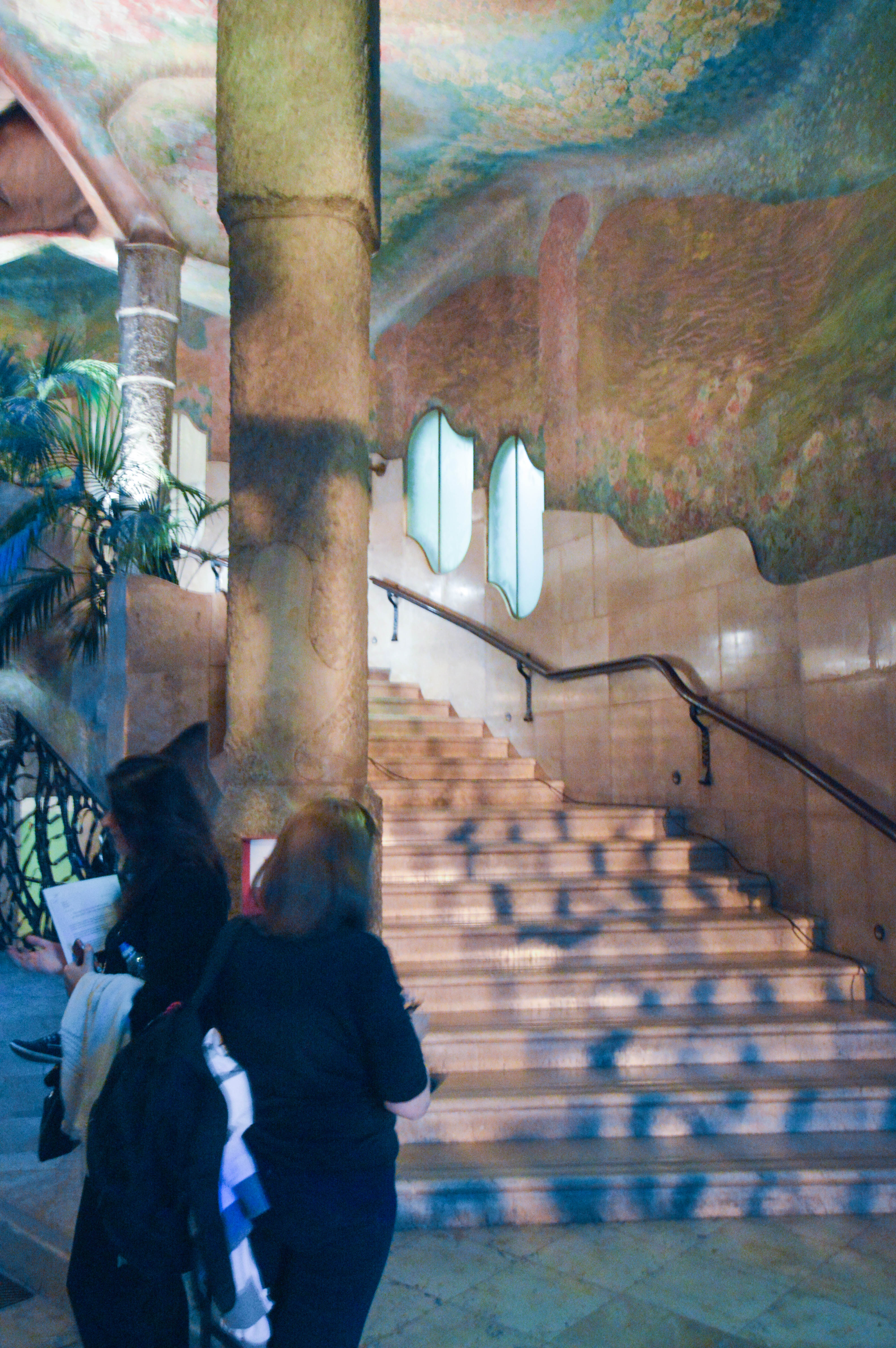 interior space with a staircase, columns, and large windows