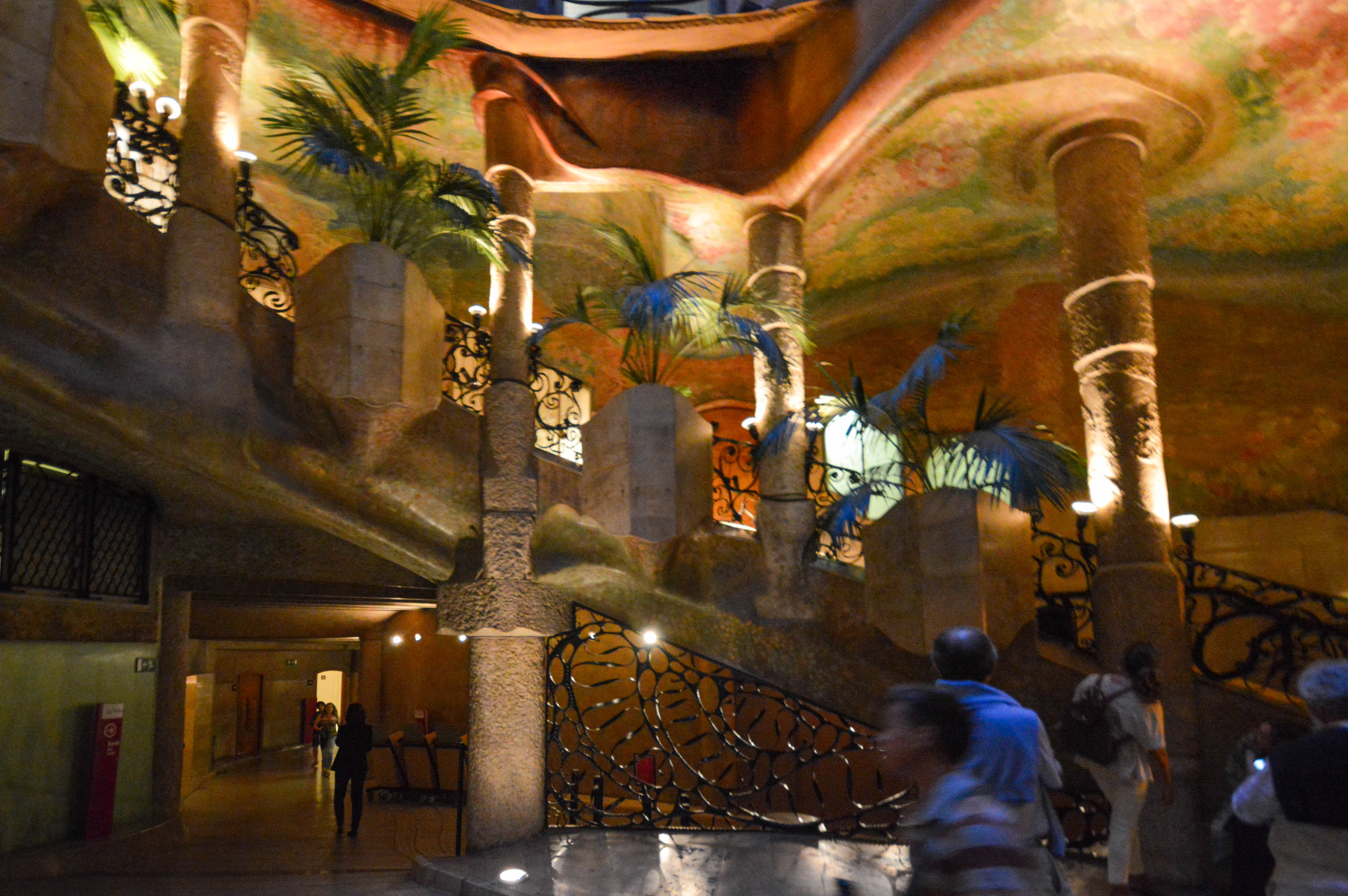 a ceiling painted with palm trees and a sunset or sunrise sky