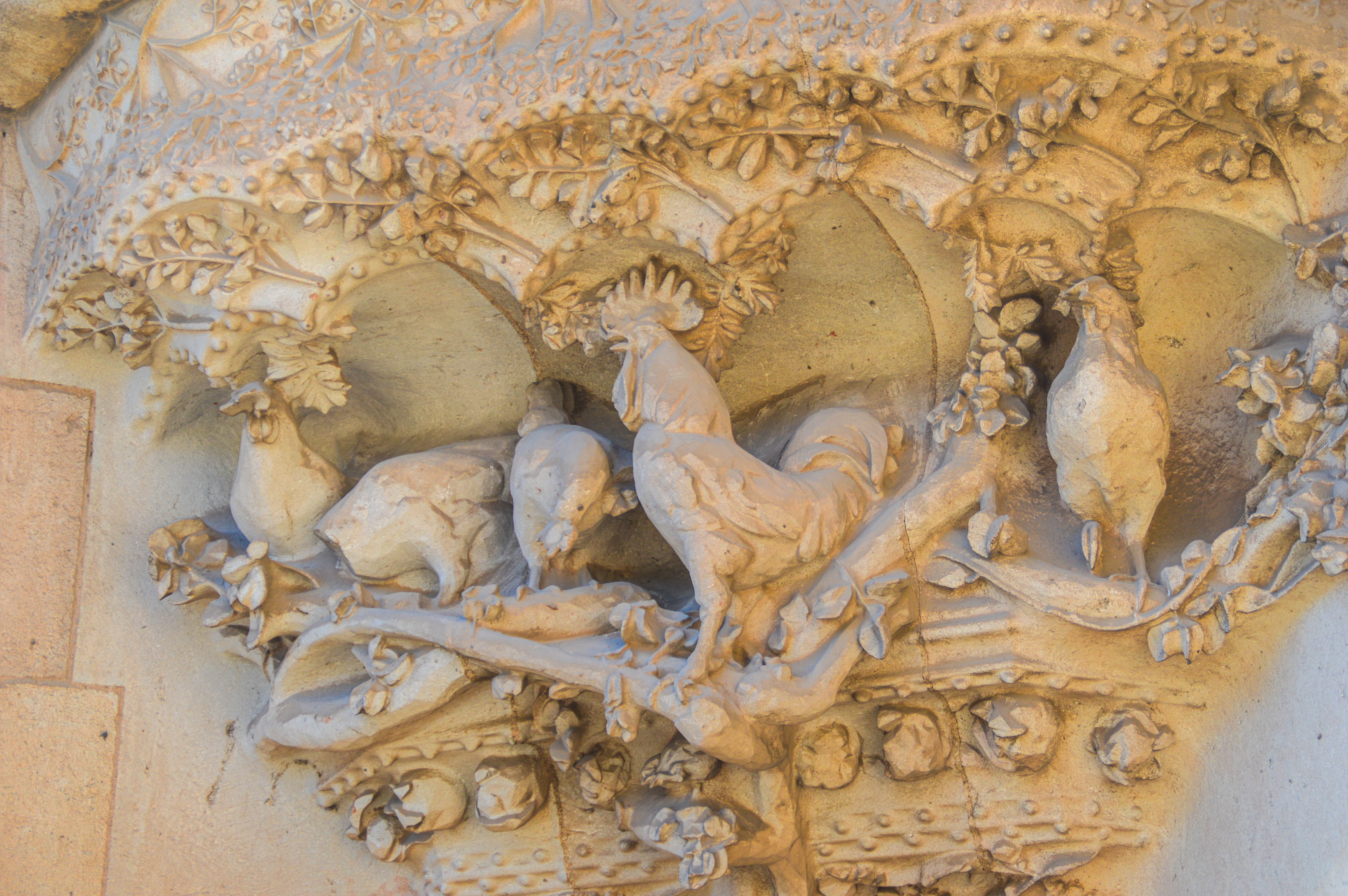 carving featuring a rooster and three chicks