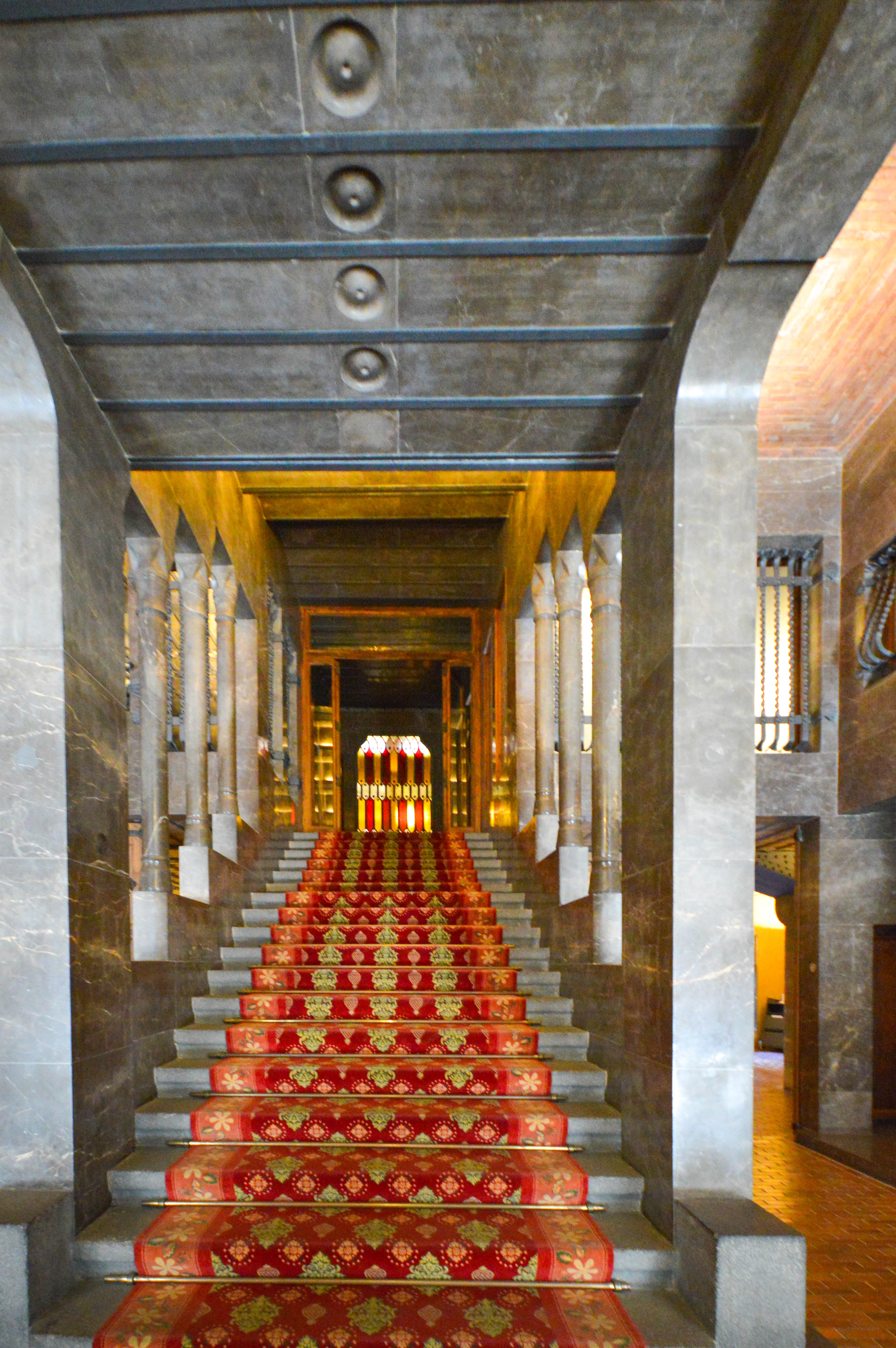 a grand staircase with a red carpet