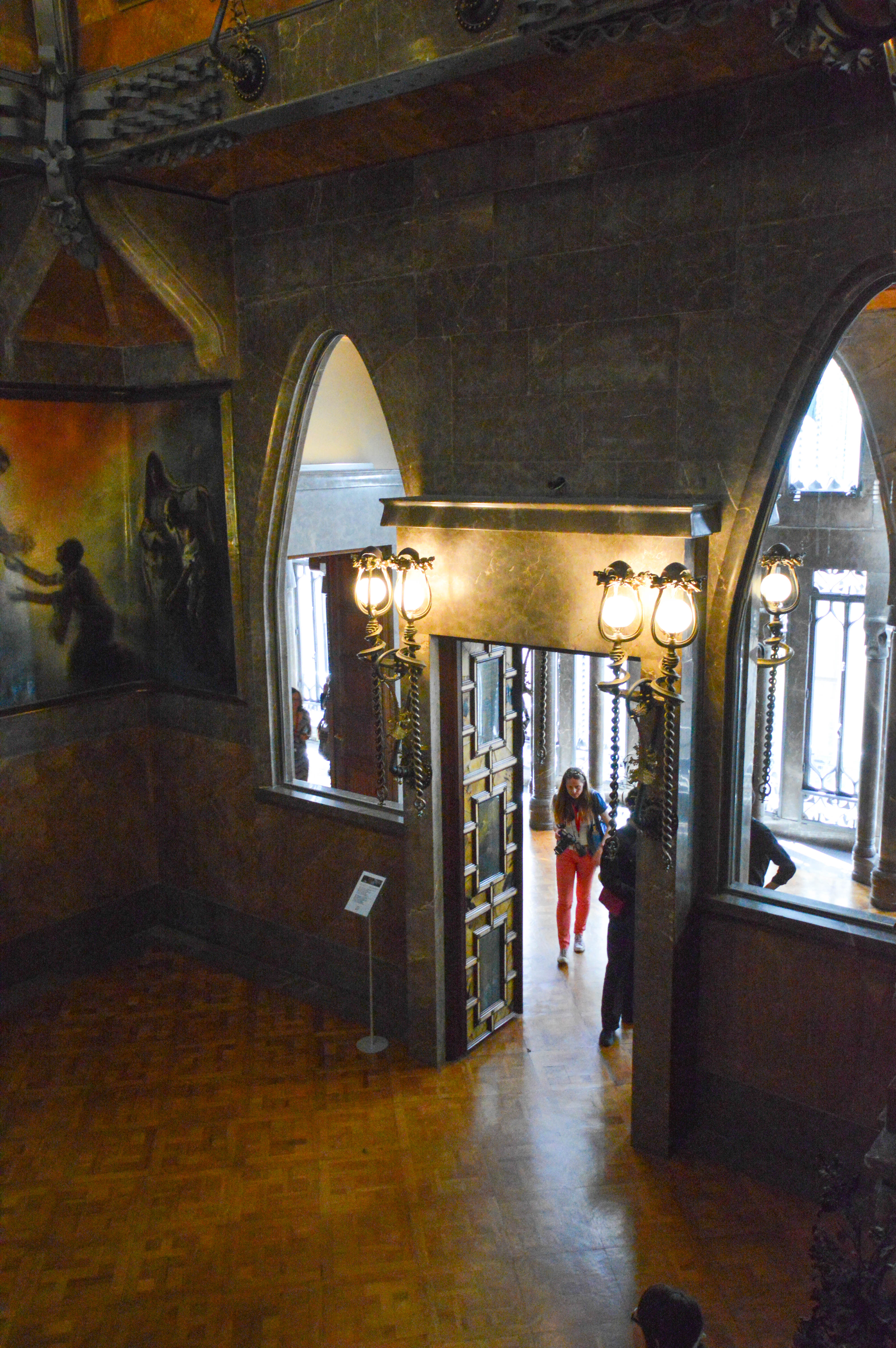 interior hallway with arched windows and ornate lighting fixtures