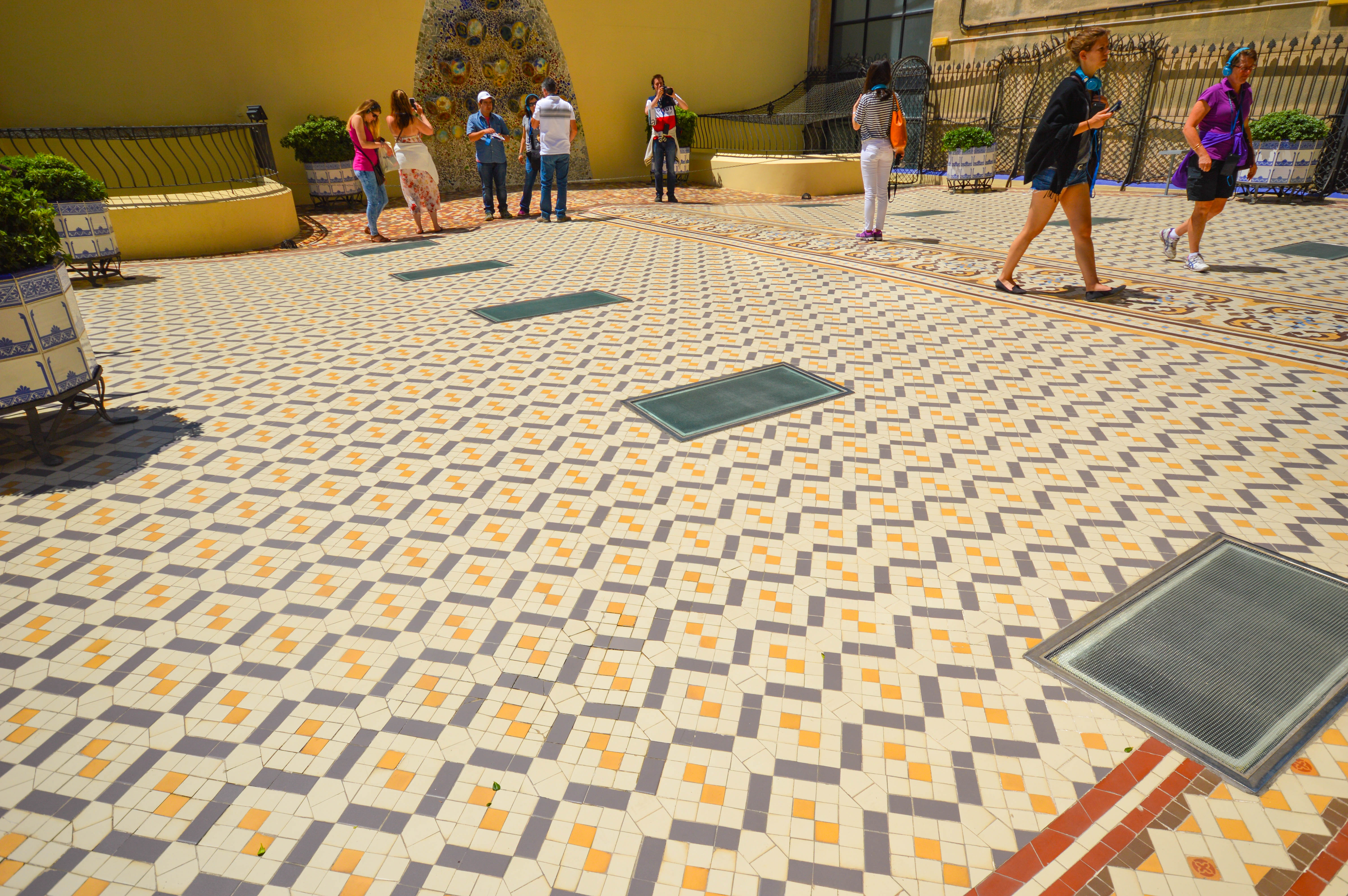 a courtyard with a patterned tiled floor