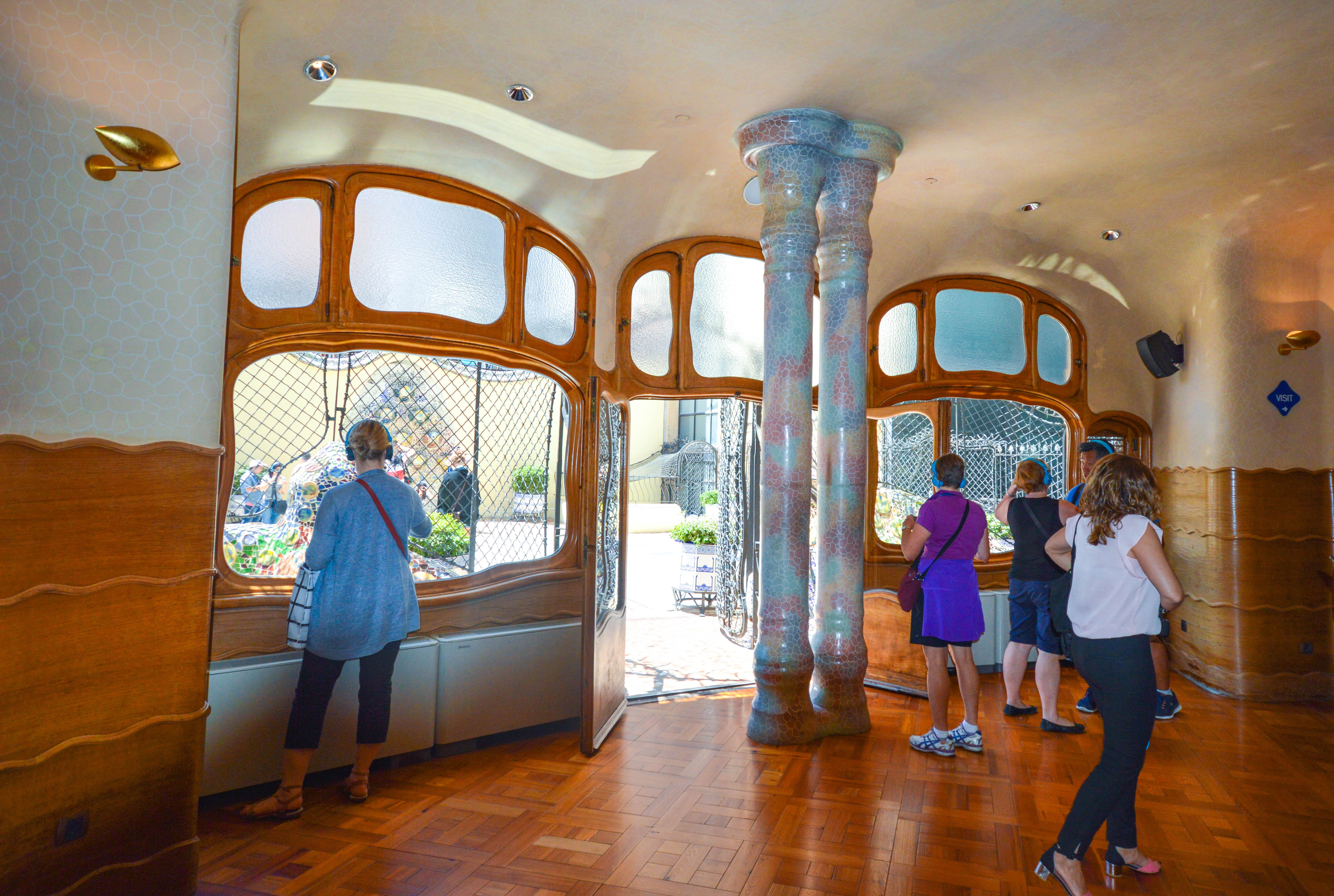 distinctive architecture with curved lines, mosaic tiles, and stained glass windows