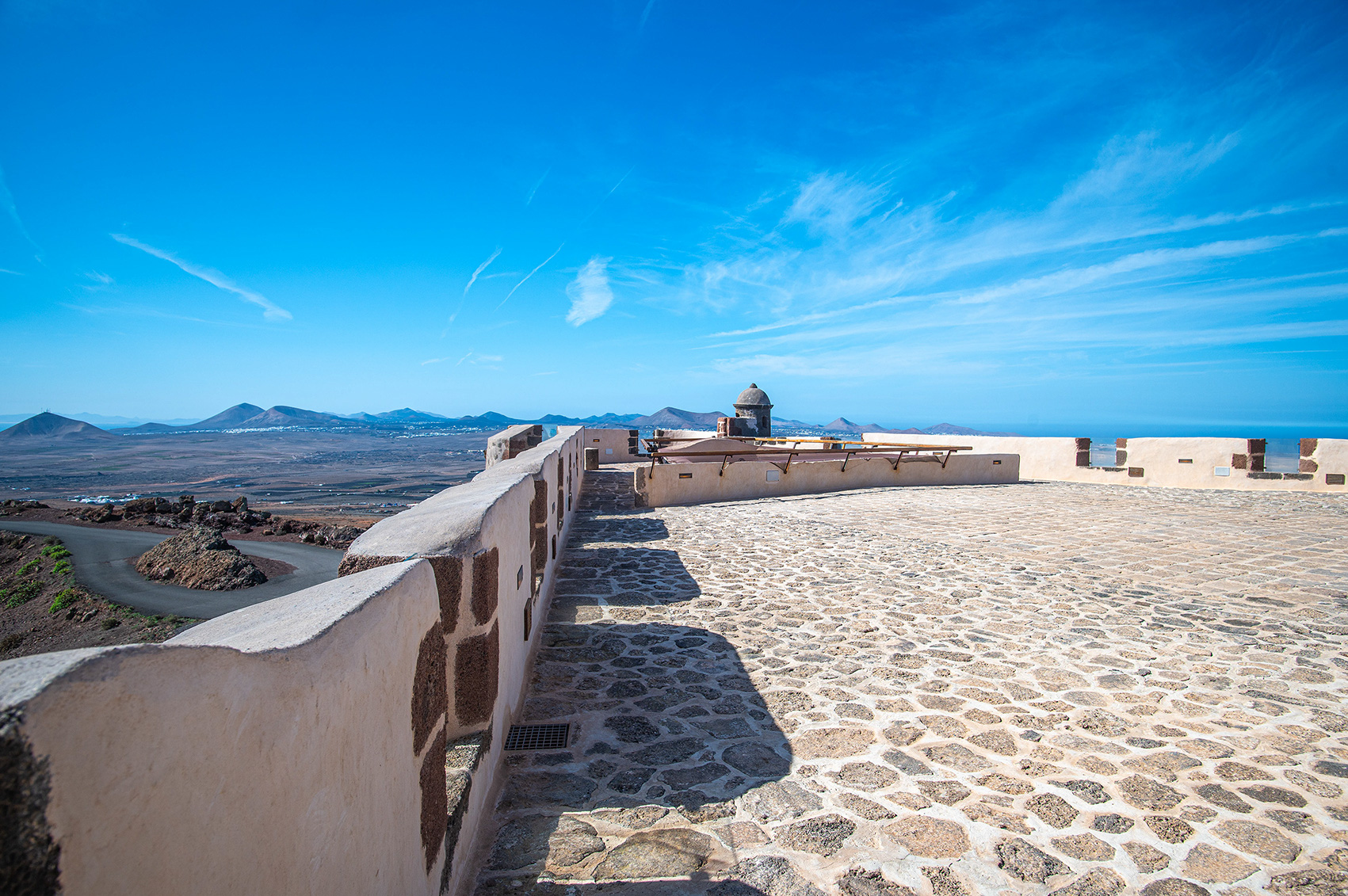 stone walls and a cobblestone pathway leading to a lookout point