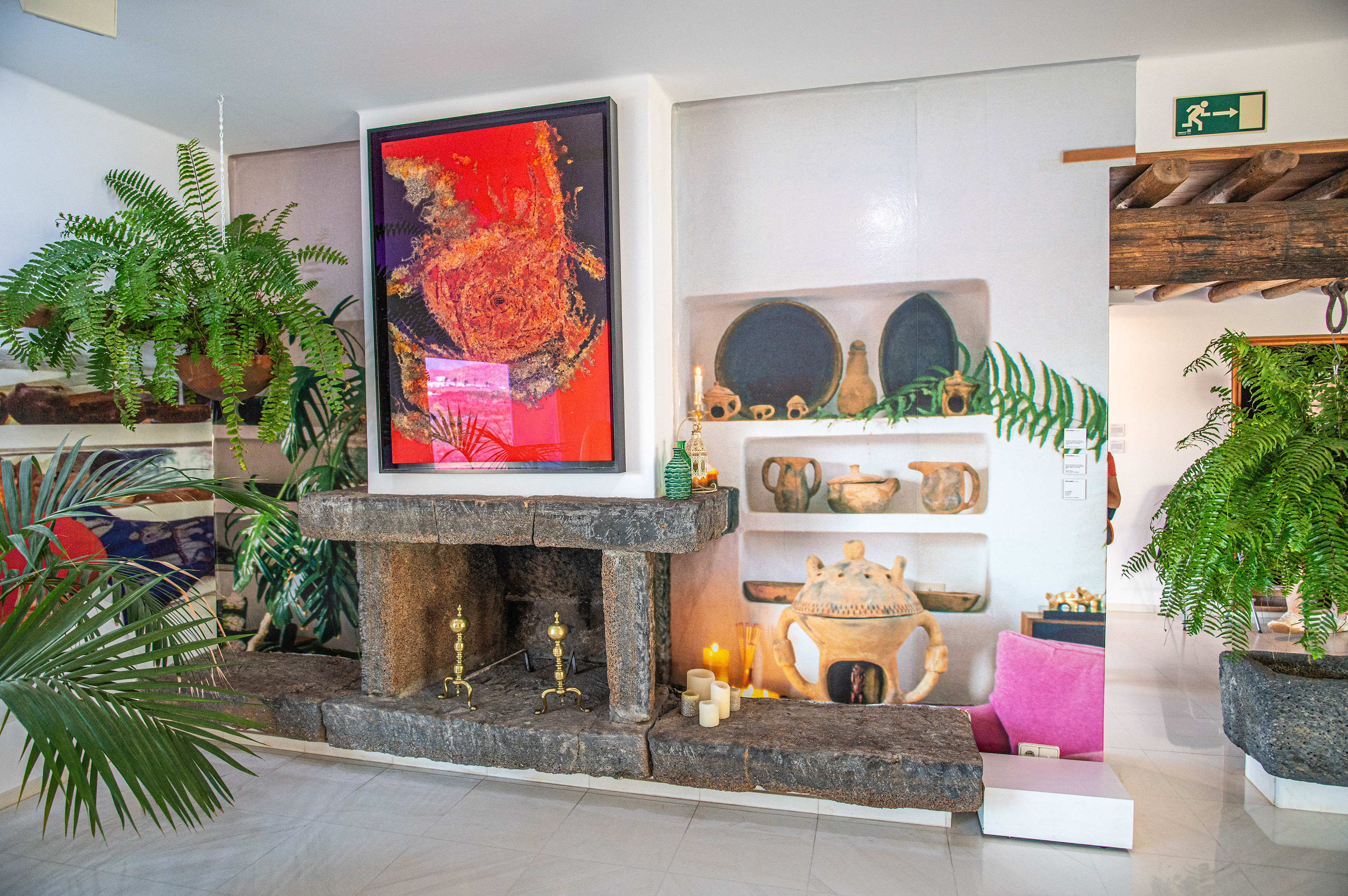 a large, vibrant abstract painting featuring bold red, orange, and black