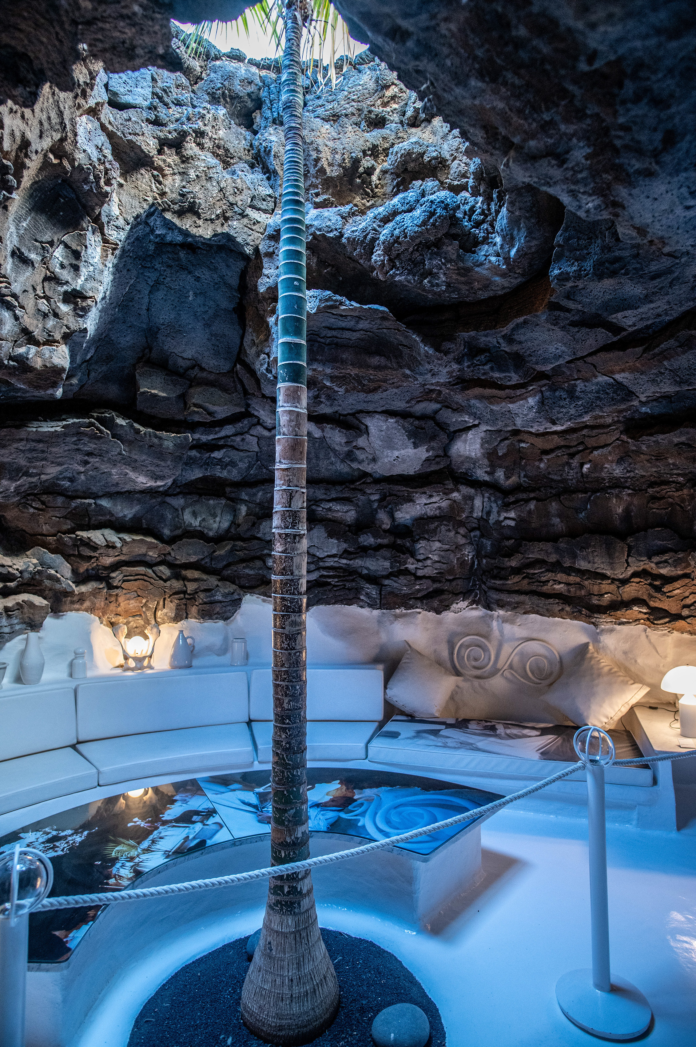 well-lit tunnel within a rocky cavern