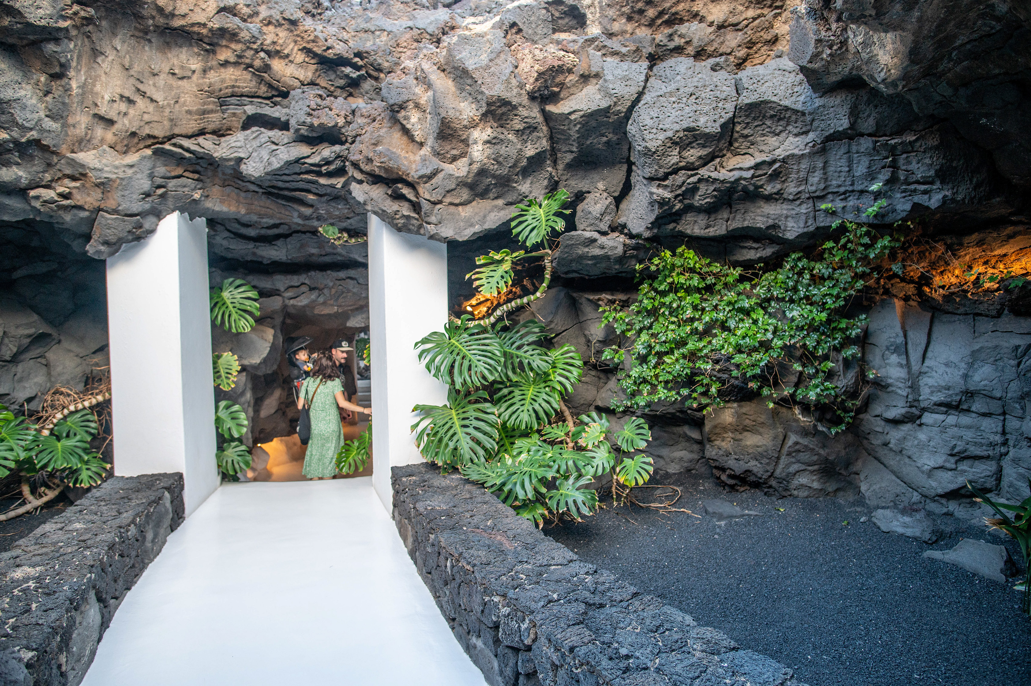 a cave-like structure adorned with lush greenery