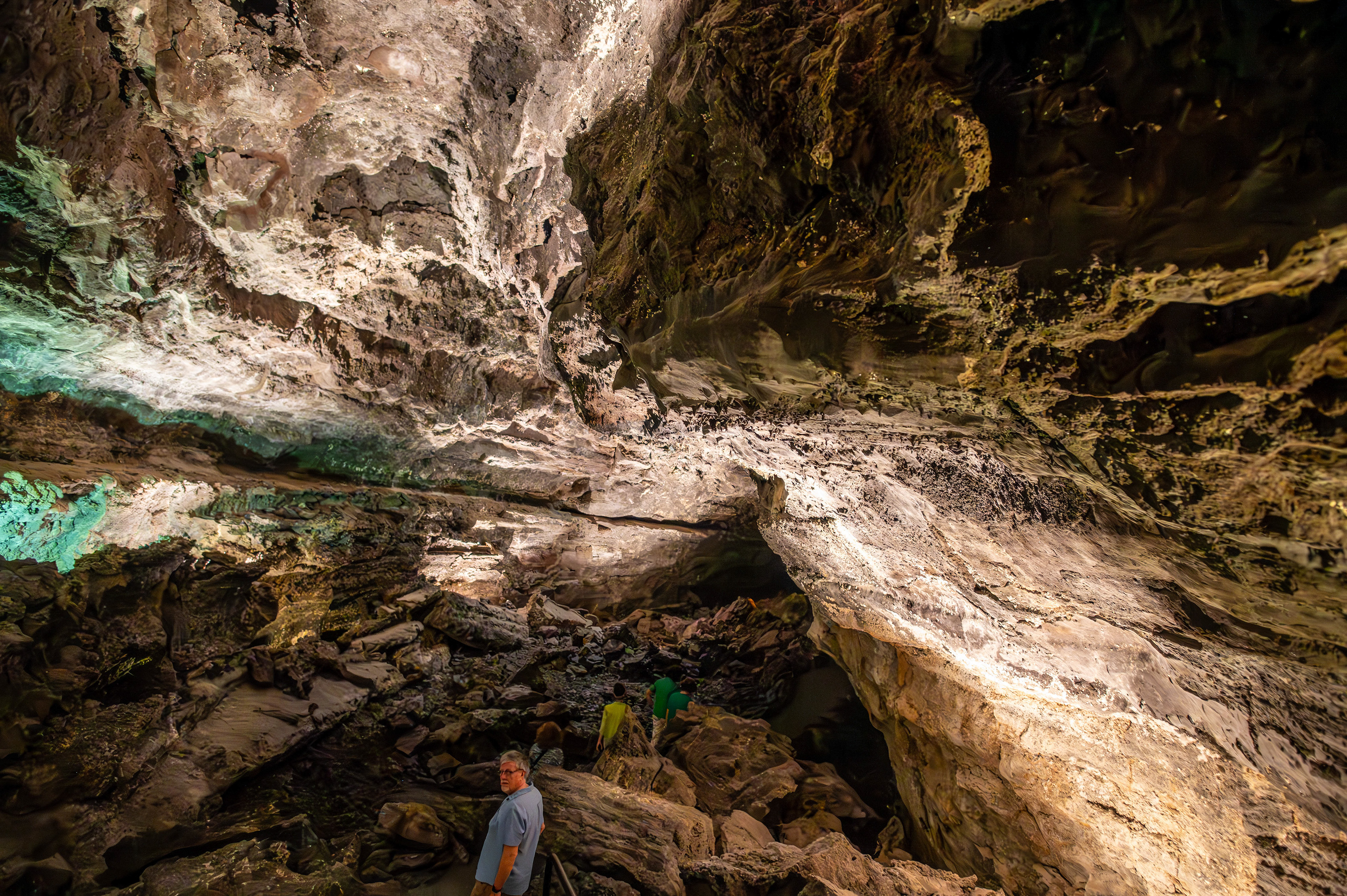 The cave interior features a variety of rock formations and mineral deposits