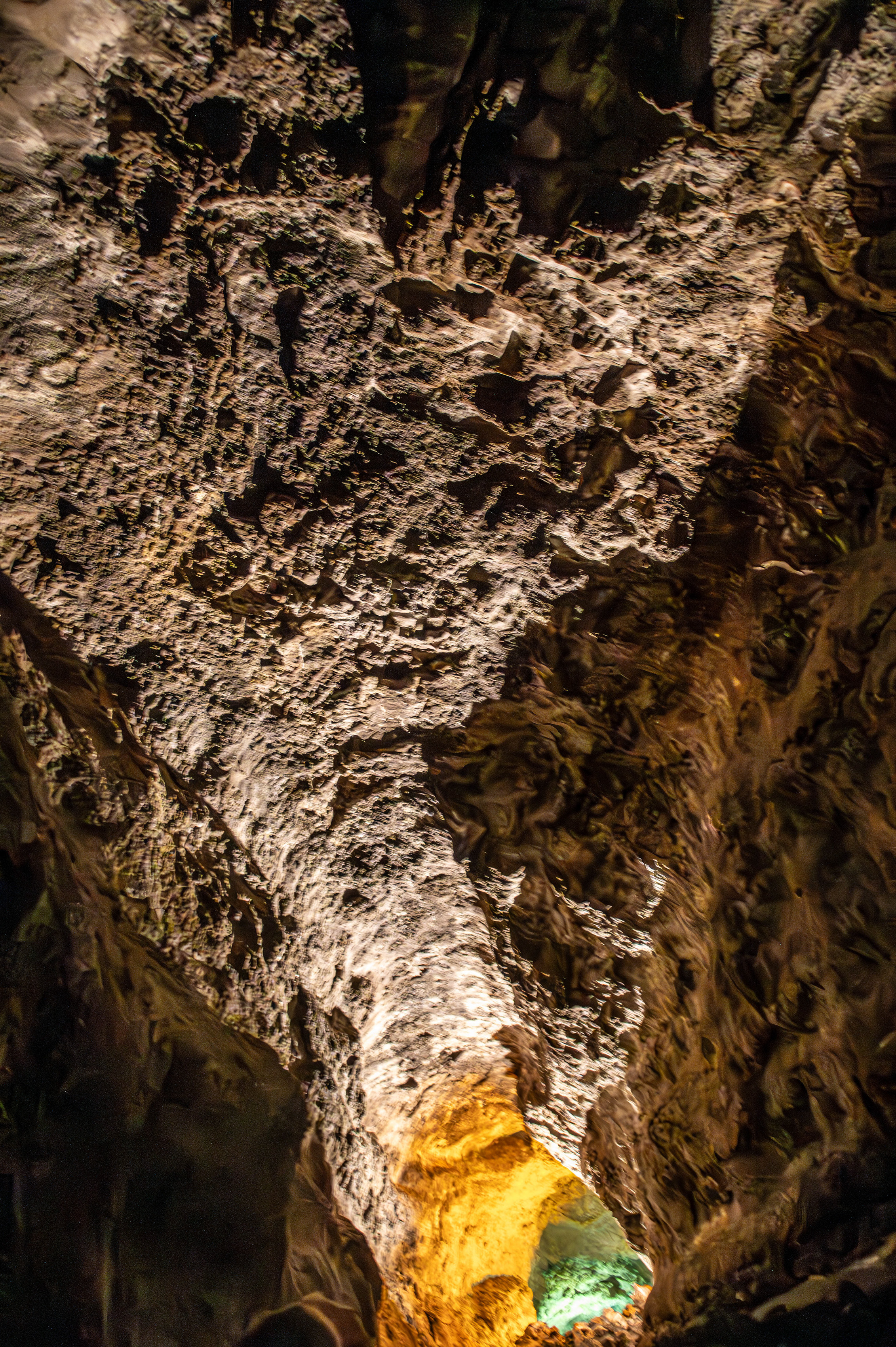 A beam of light illuminates the cave