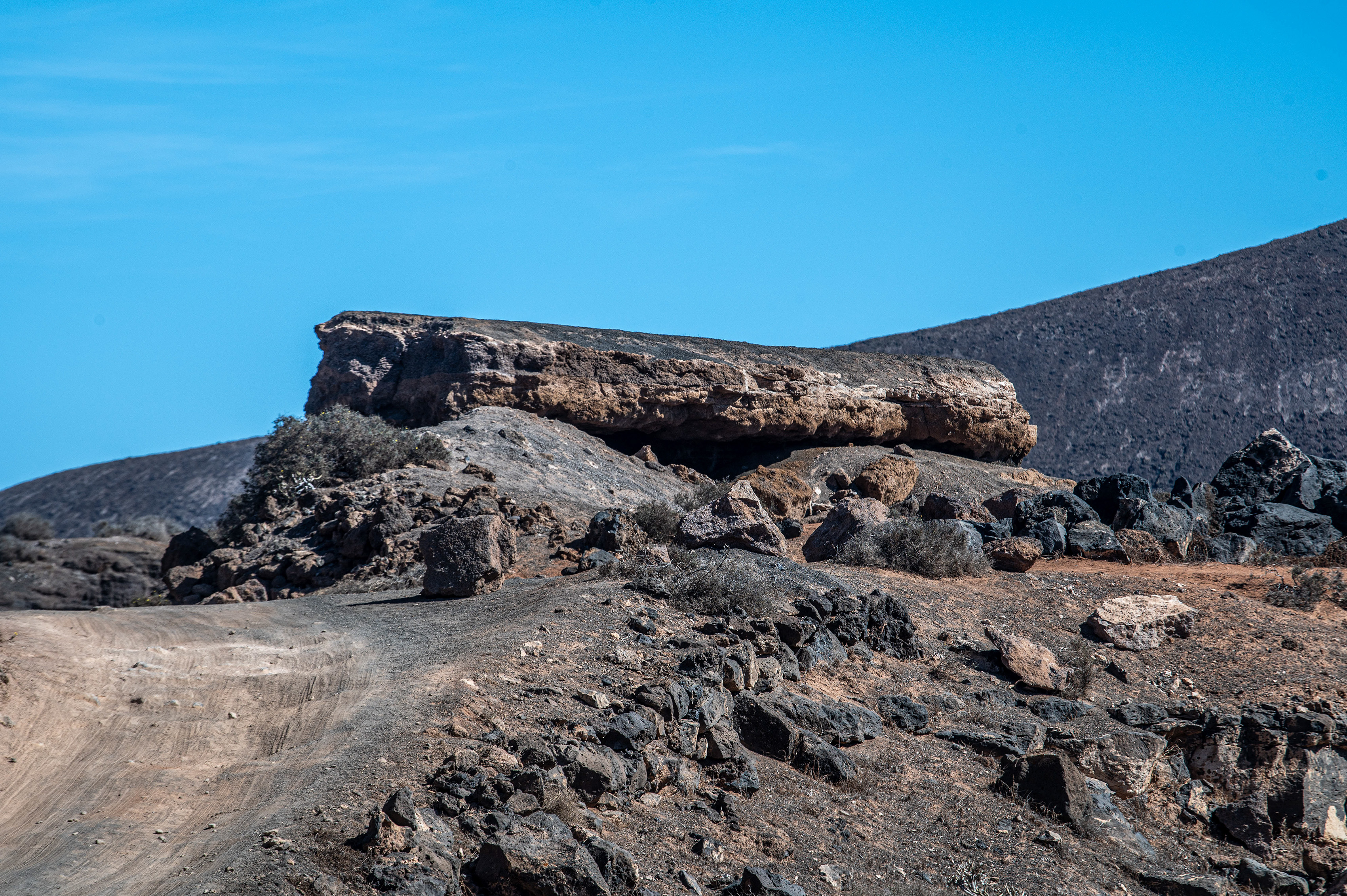 a prominent rock formation in the foreground
