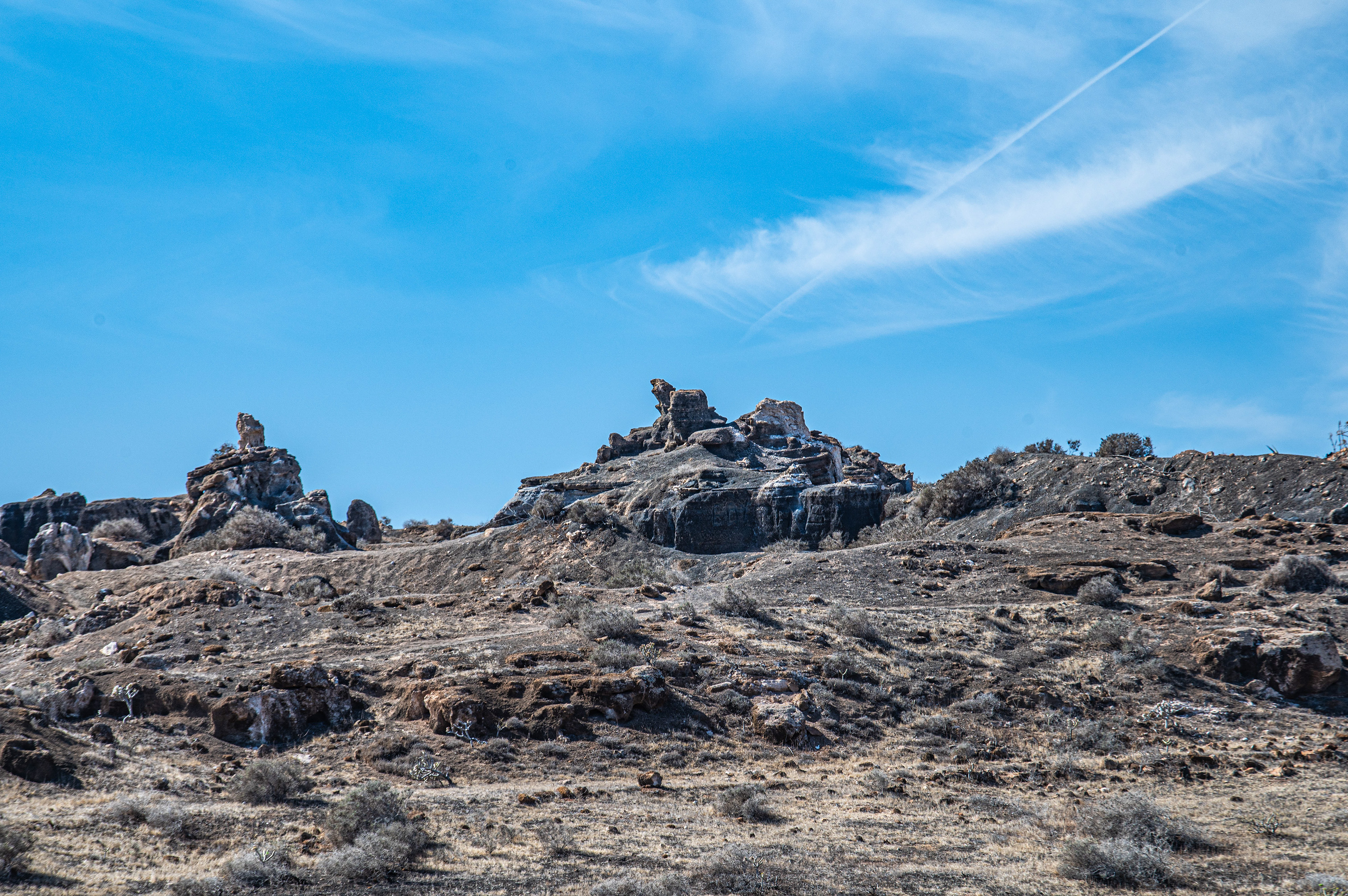 uneven terrain with large rocks and boulders scattered across it.