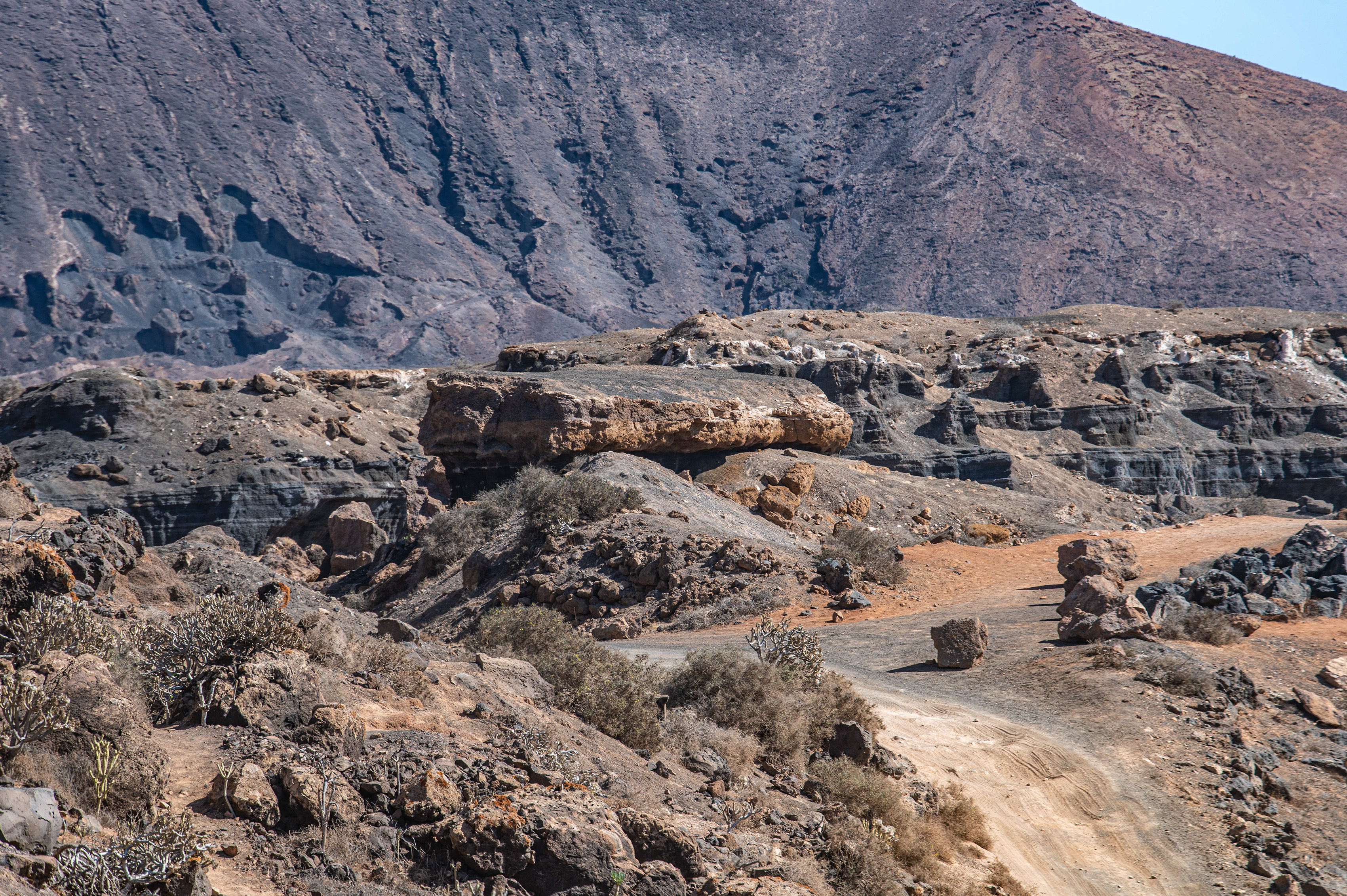 a rugged, rocky landscape with a dirt path winding through it