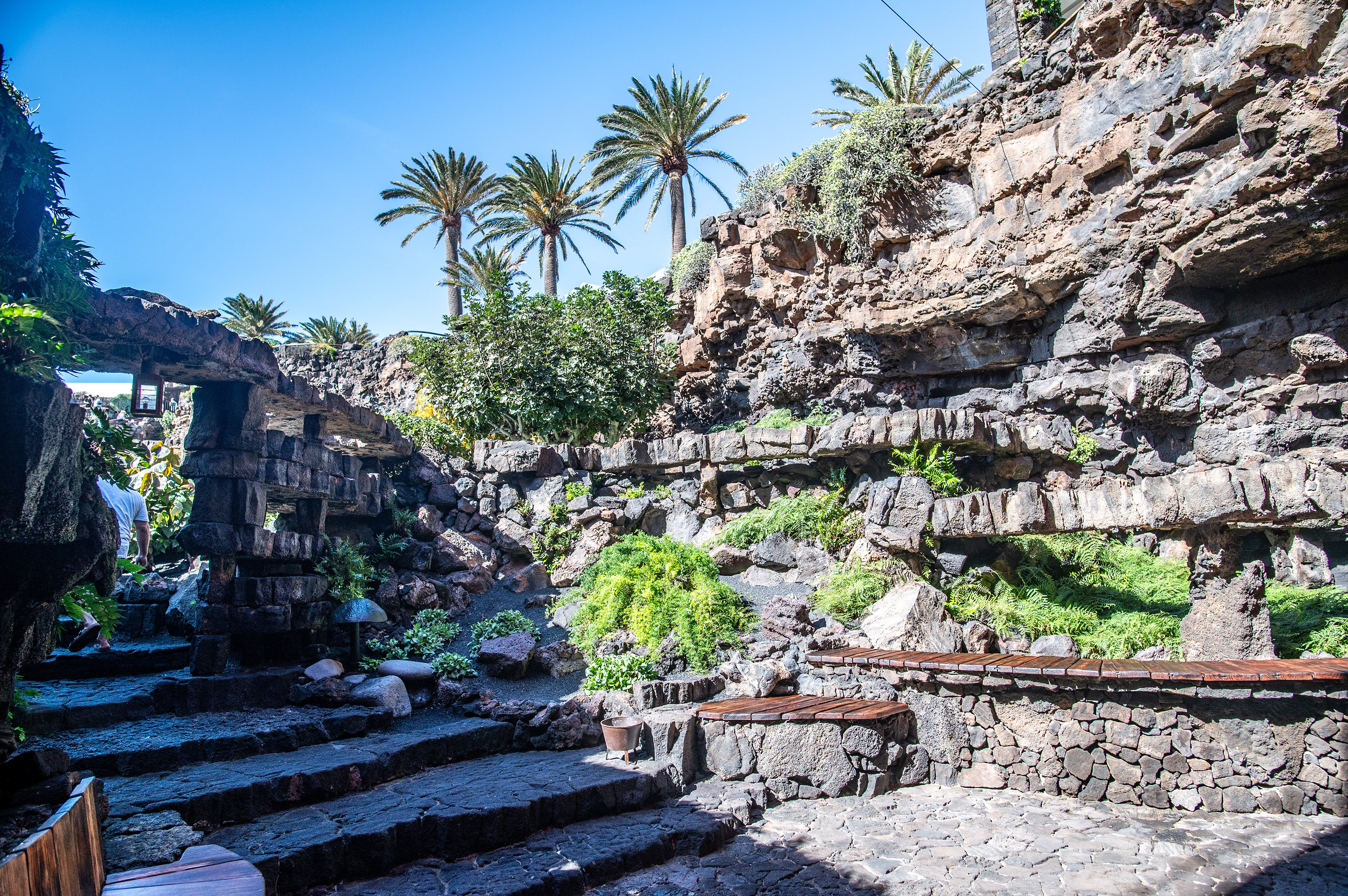 an outdoor seating area built into a rocky hillside