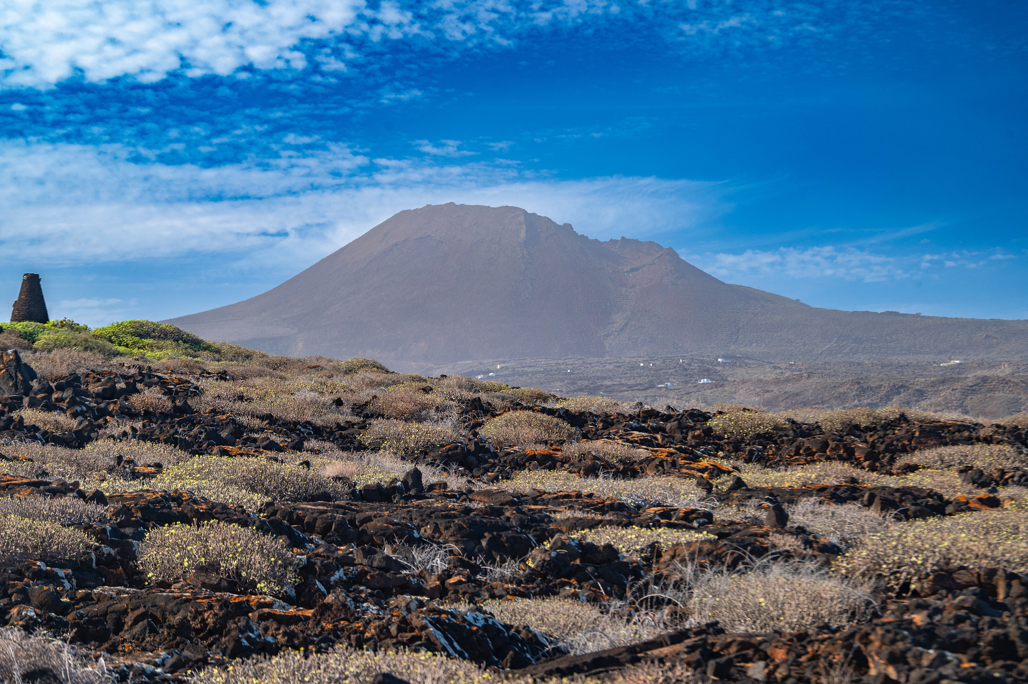 In the background, there is a prominent volcano