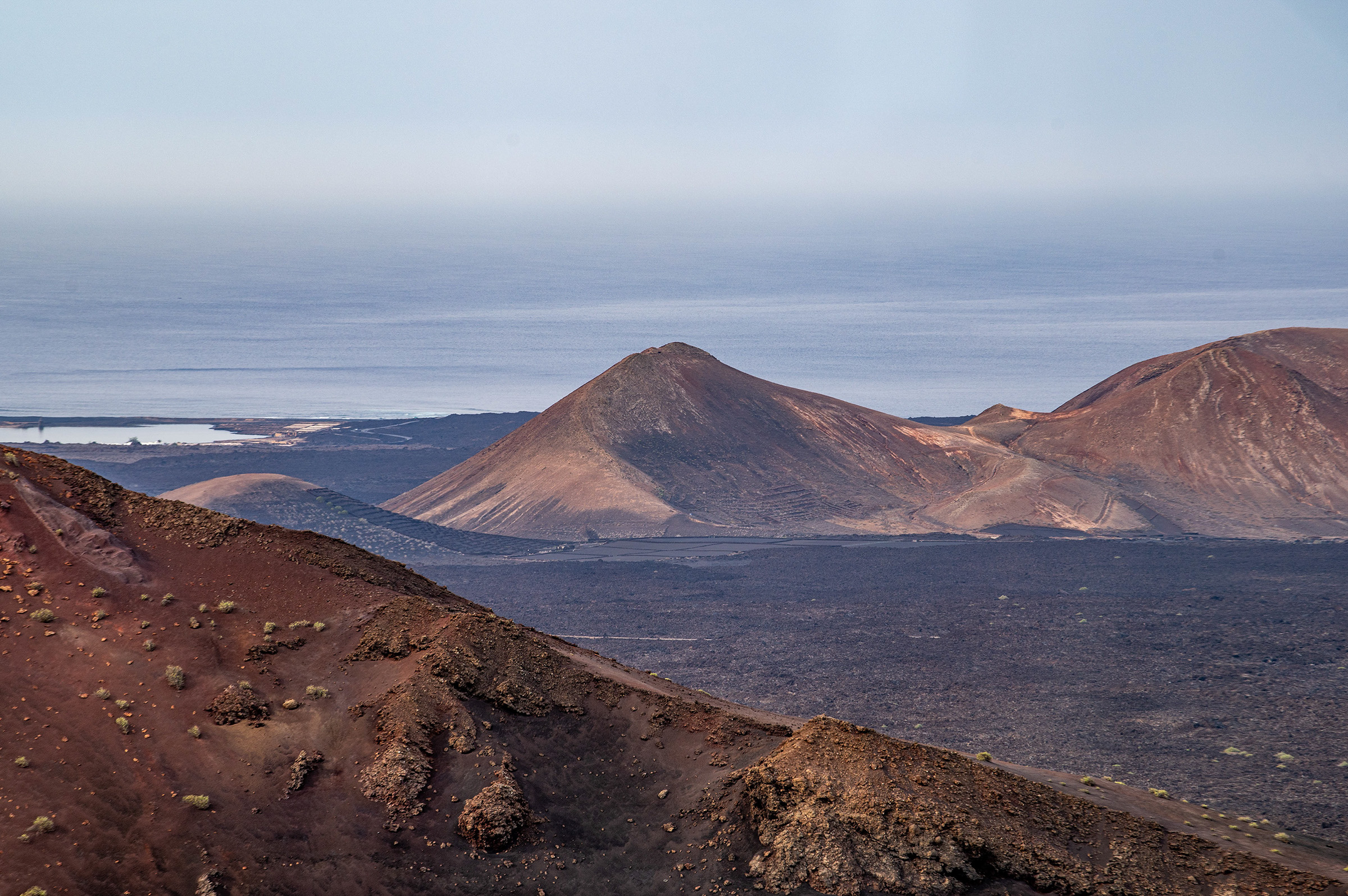 prominent volcano in the center, surrounded by smaller volcanic hills