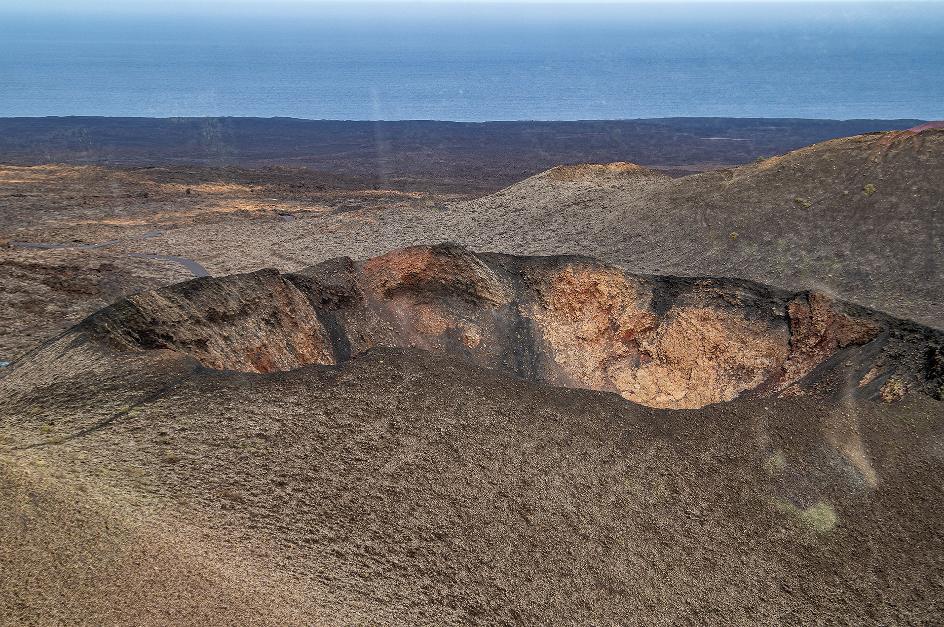 volcanic landscape with a crater in the foreground