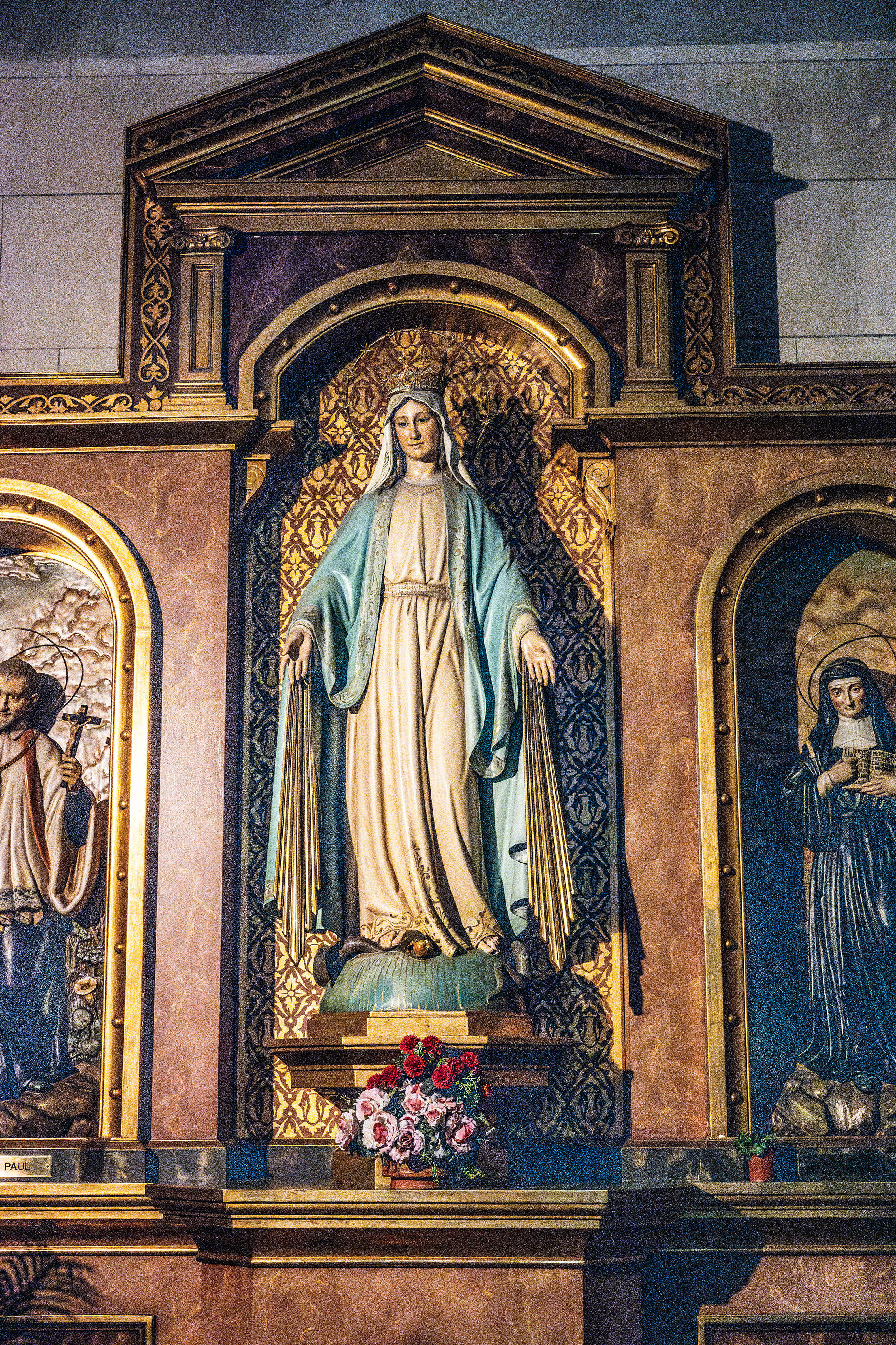 the Virgin Mary, adorned with a blue cloak and a crown