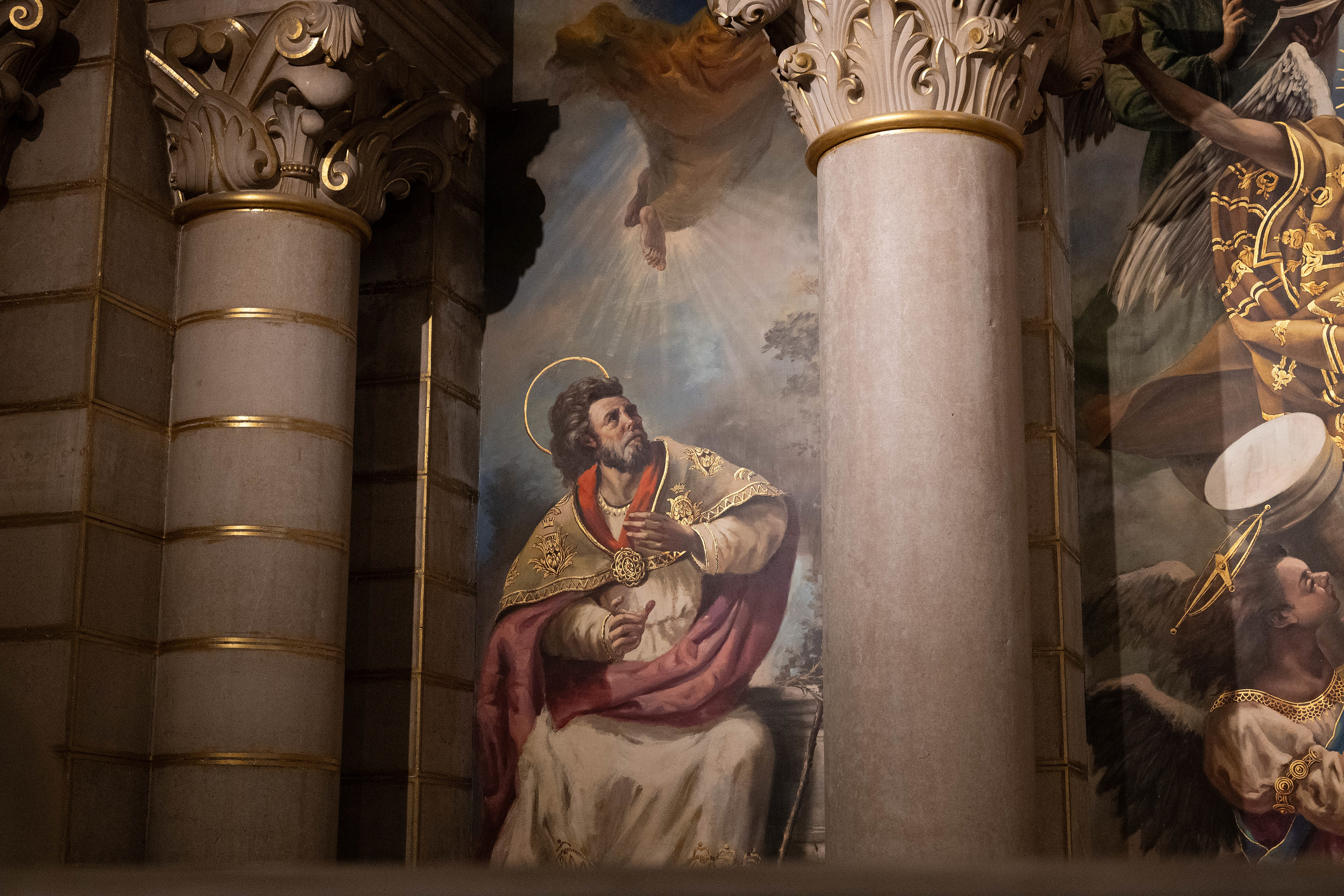 a saint, adorned in ecclesiastical garments with a halo around his head