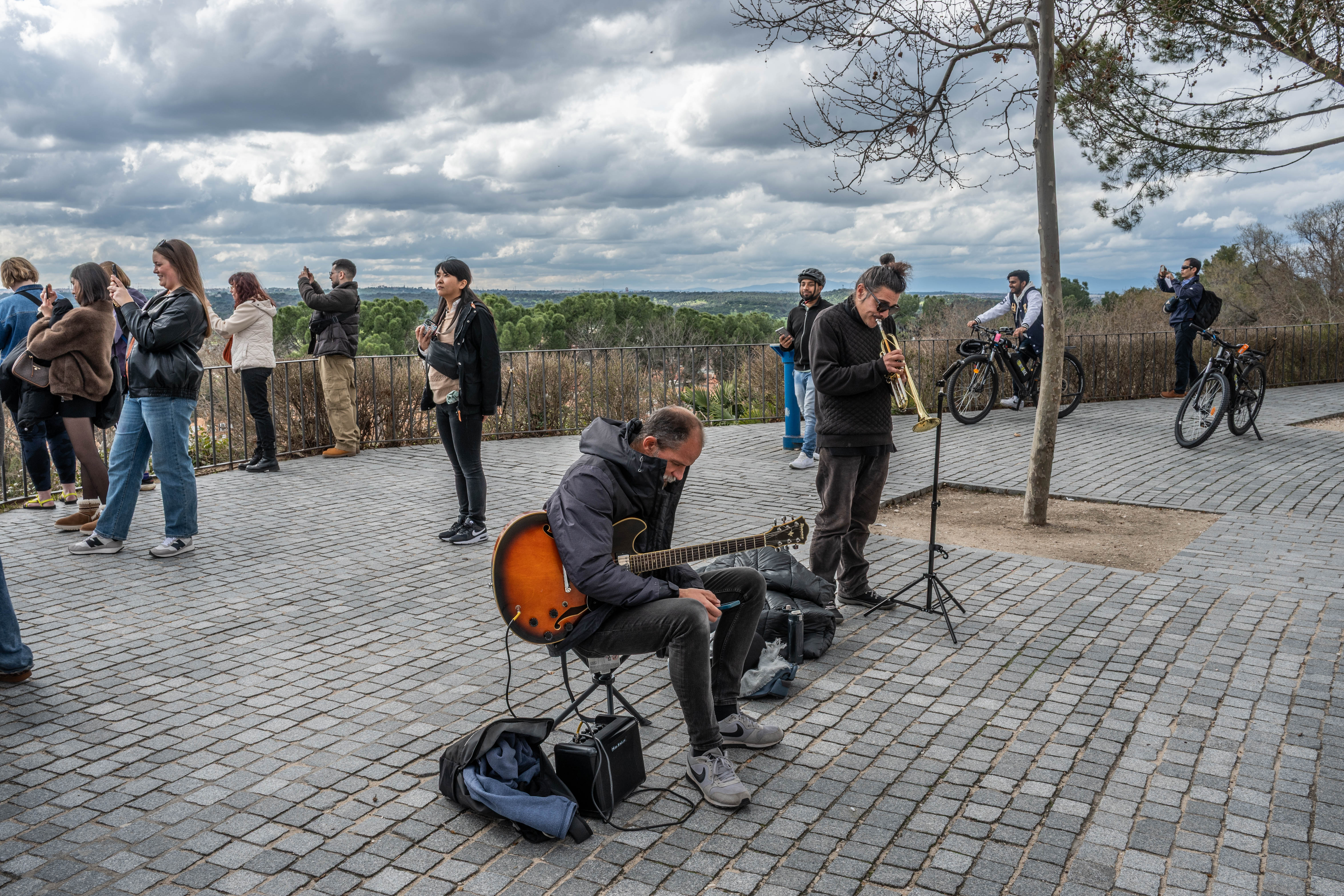 street performance scene with a guitarist and a trumpeter playing music